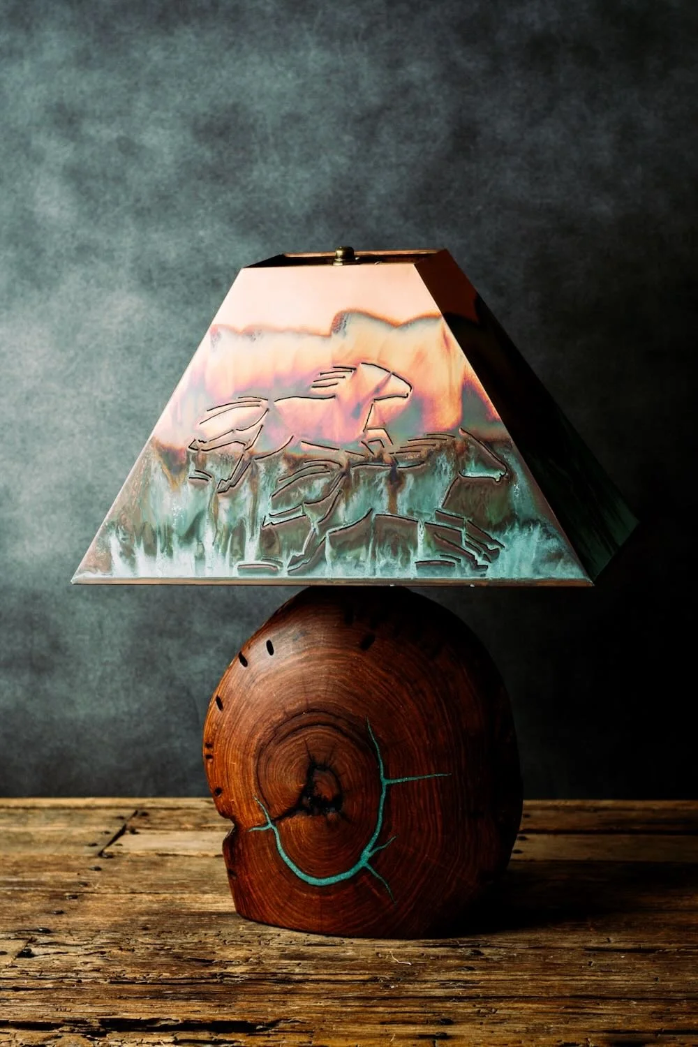 Shop a handmade mesquite wood and copper table lamp with turquoise inlay. Southwestern artisan lighting with running horses design and rustic luxury style.