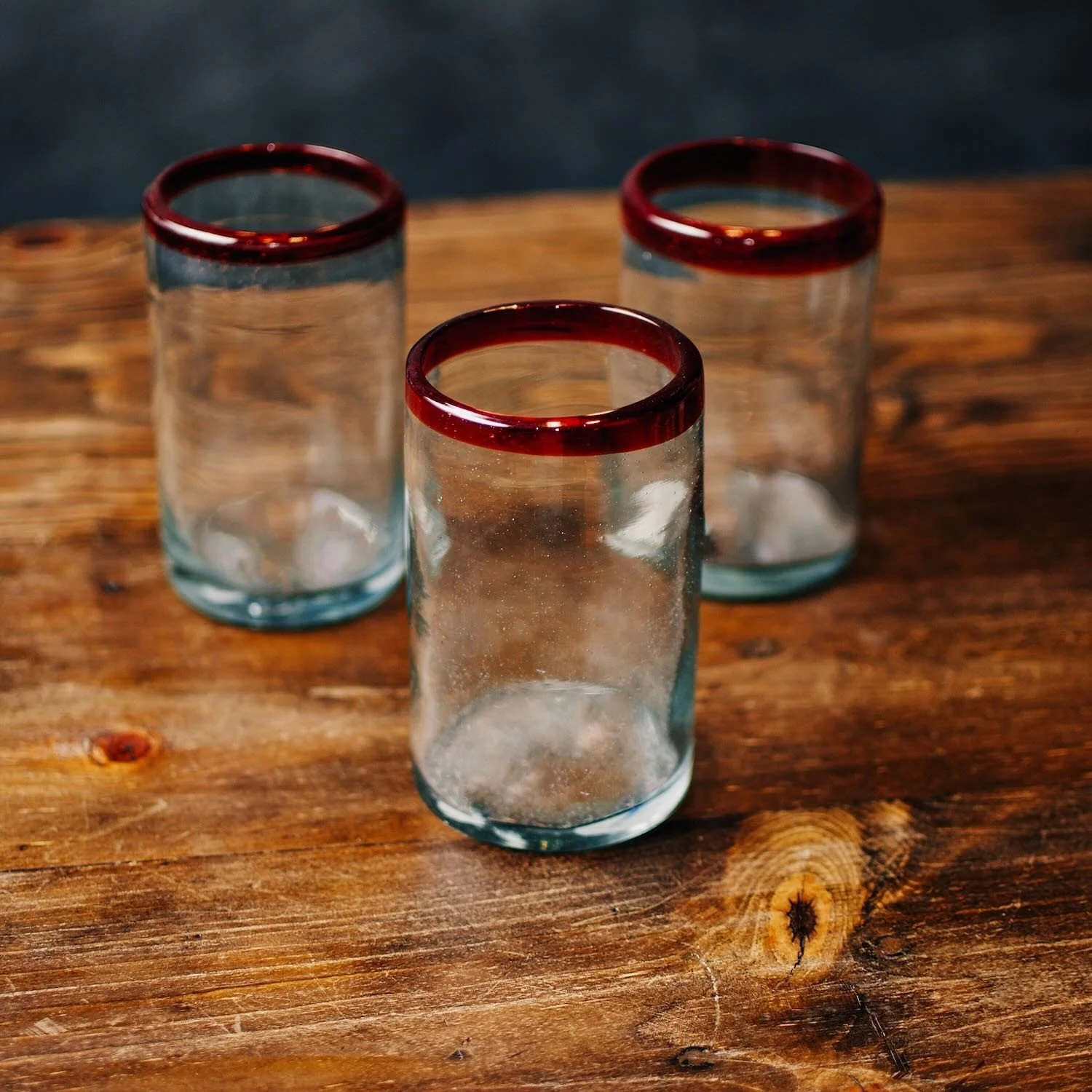 Handmade Mexican Cantina tall glass with traditional red rim and handblown artisan craftsmanship.