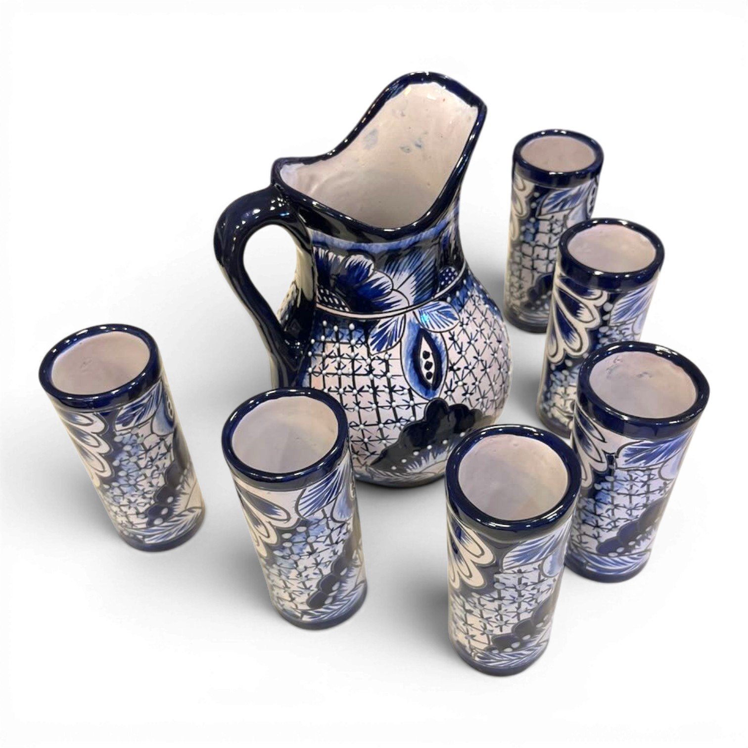 Handmade Mexican blue and white Talavera pitcher with six matching hand-painted tumblers.