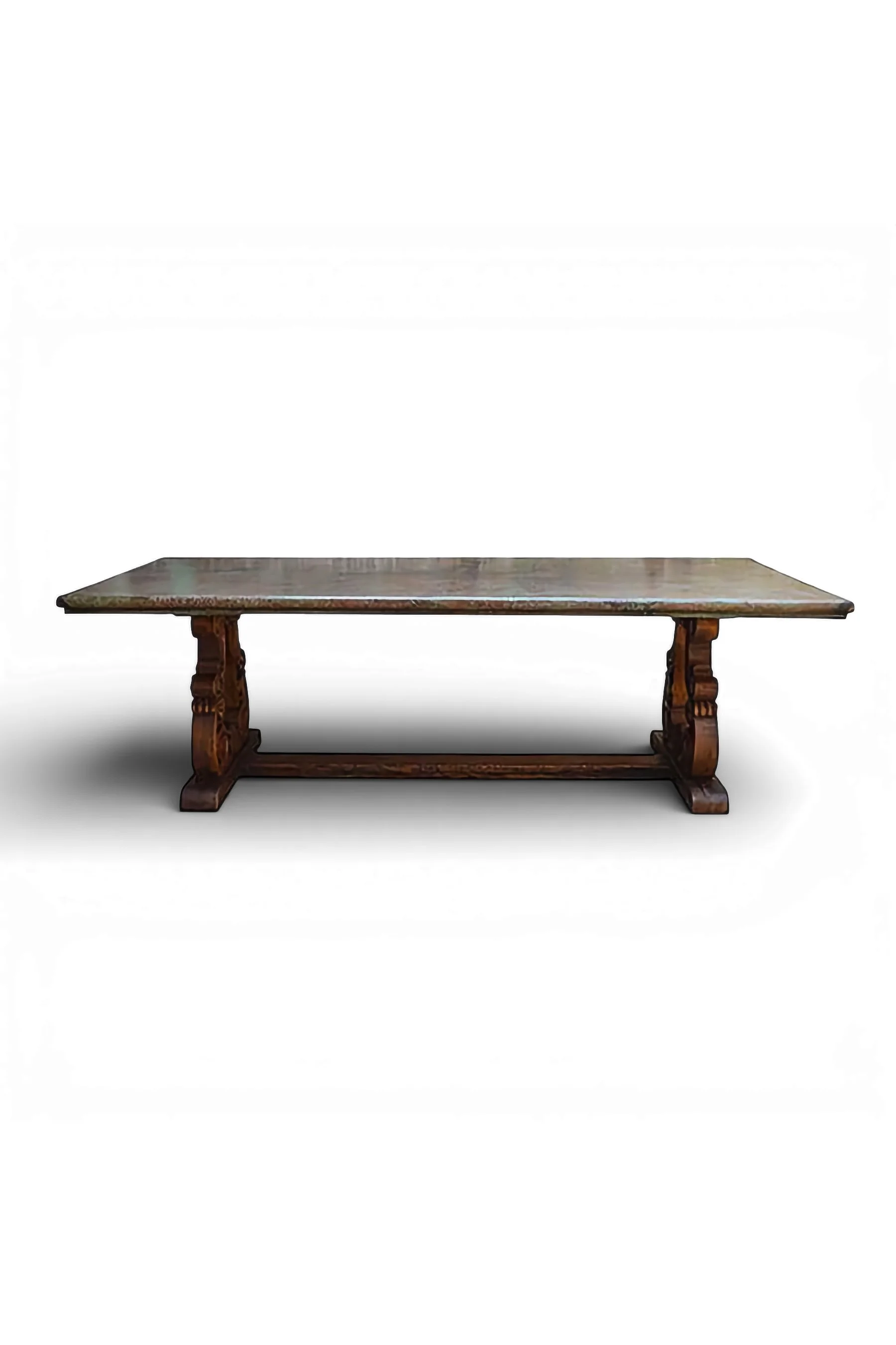 Shop a handmade copper dining table from Mexico. Verdigris copper top with carved wood base, perfect for rustic luxury dining spaces.