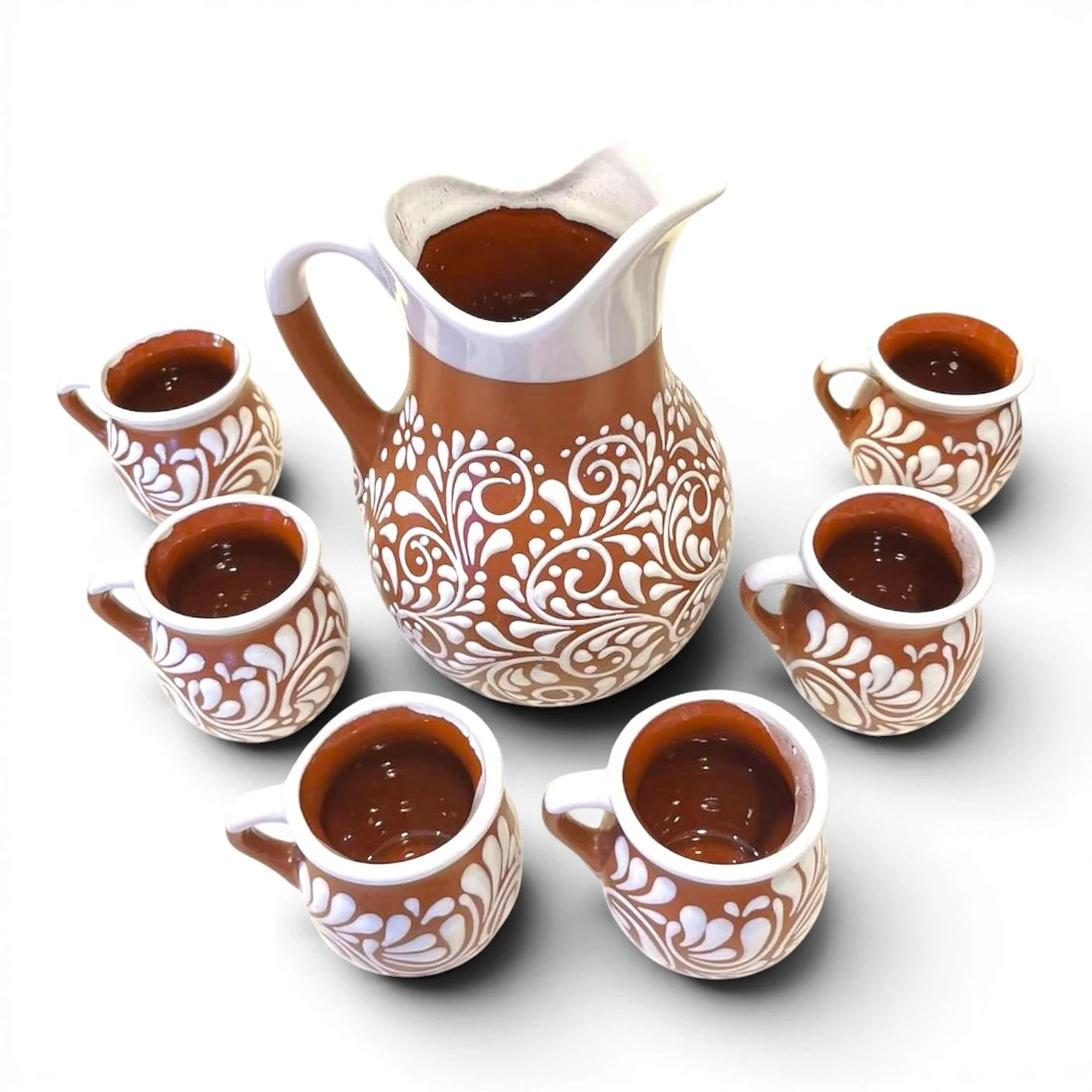 Handcrafted Mexican barro pitcher with white Talavera-inspired design and six matching clay cups.