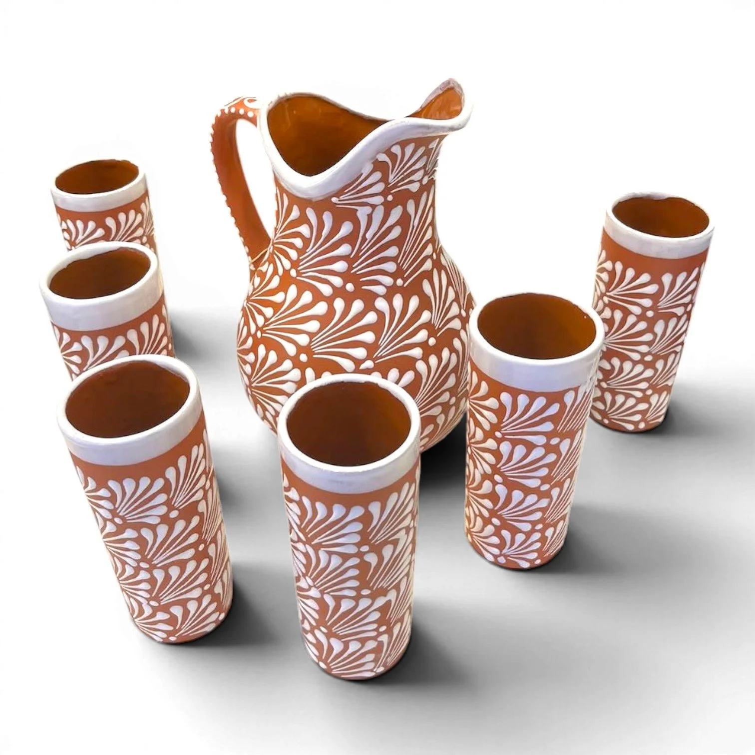 Handcrafted Mexican terracotta pitcher and tumbler set with white Talavera-style design and glazed finish