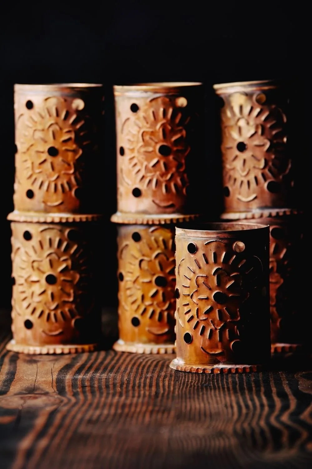 Luminarias de Bronce - Shop handmade bronze luminarias from Mexico. Elegant candle holders with punched designs, perfect for patios, walkways, and ambient lighting.
