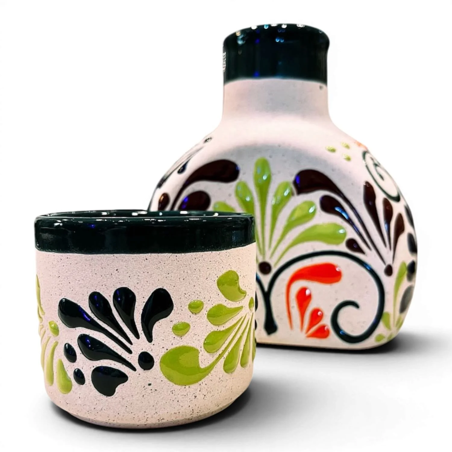 Handmade Mexican stone tequila bottle and matching shot cup with colorful hand-painted design
