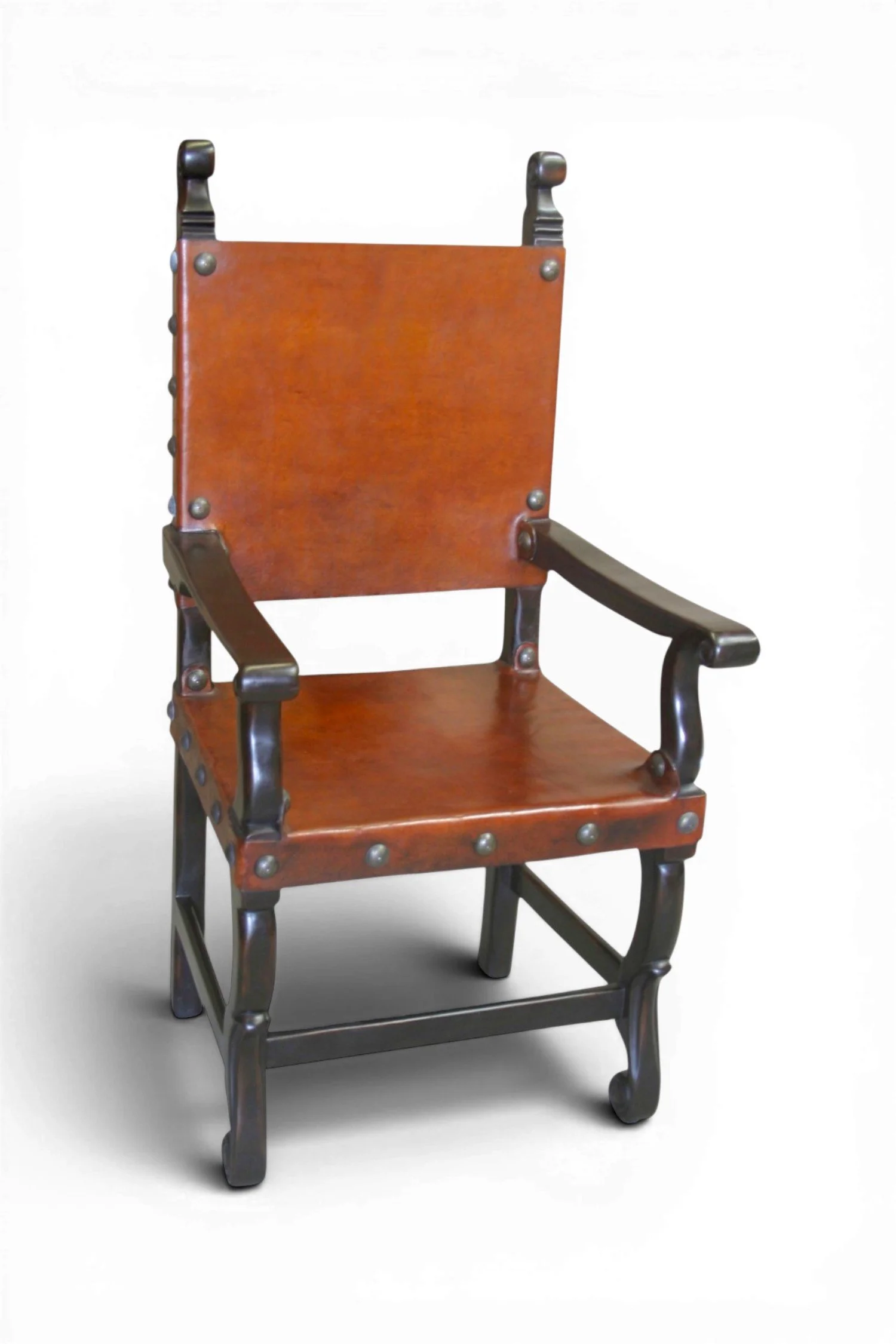 Shop a handmade leather arm dining chair from Peru. Solid wood with carved details and clavos trim for rustic luxury dining spaces.