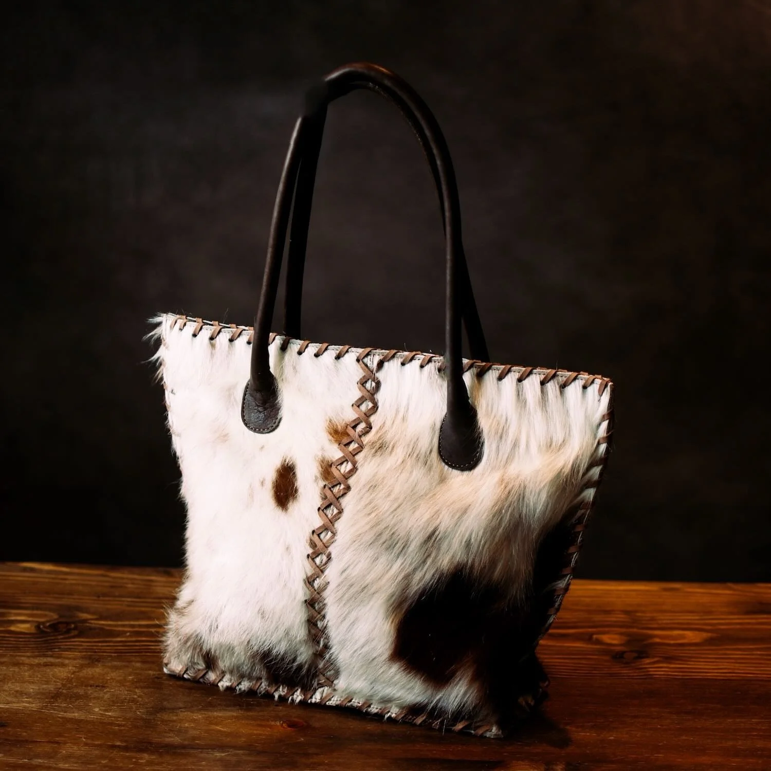 Handmade Brazilian Cheyenne cowhide tote bag with leather handles and detailed stitching