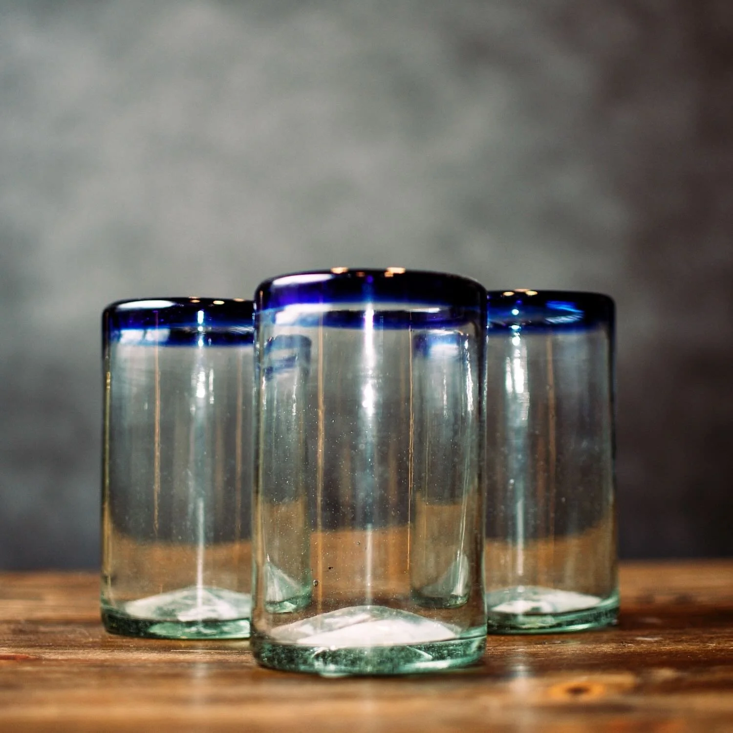 Handmade Mexican Cantina tall glass with traditional cobalt blue rim and handblown artisan craftsmanship.