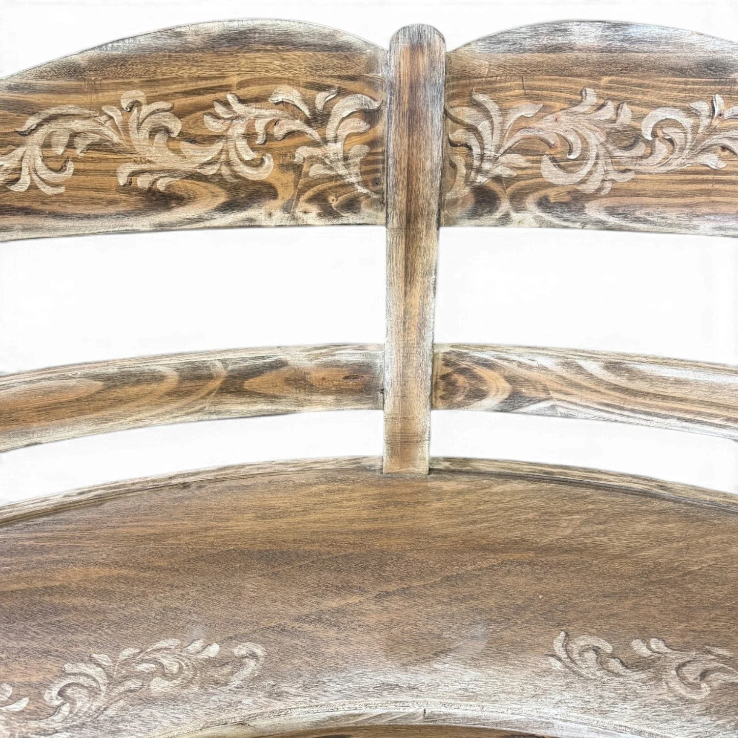 Handmade whitewashed curved wood bench with carved floral details