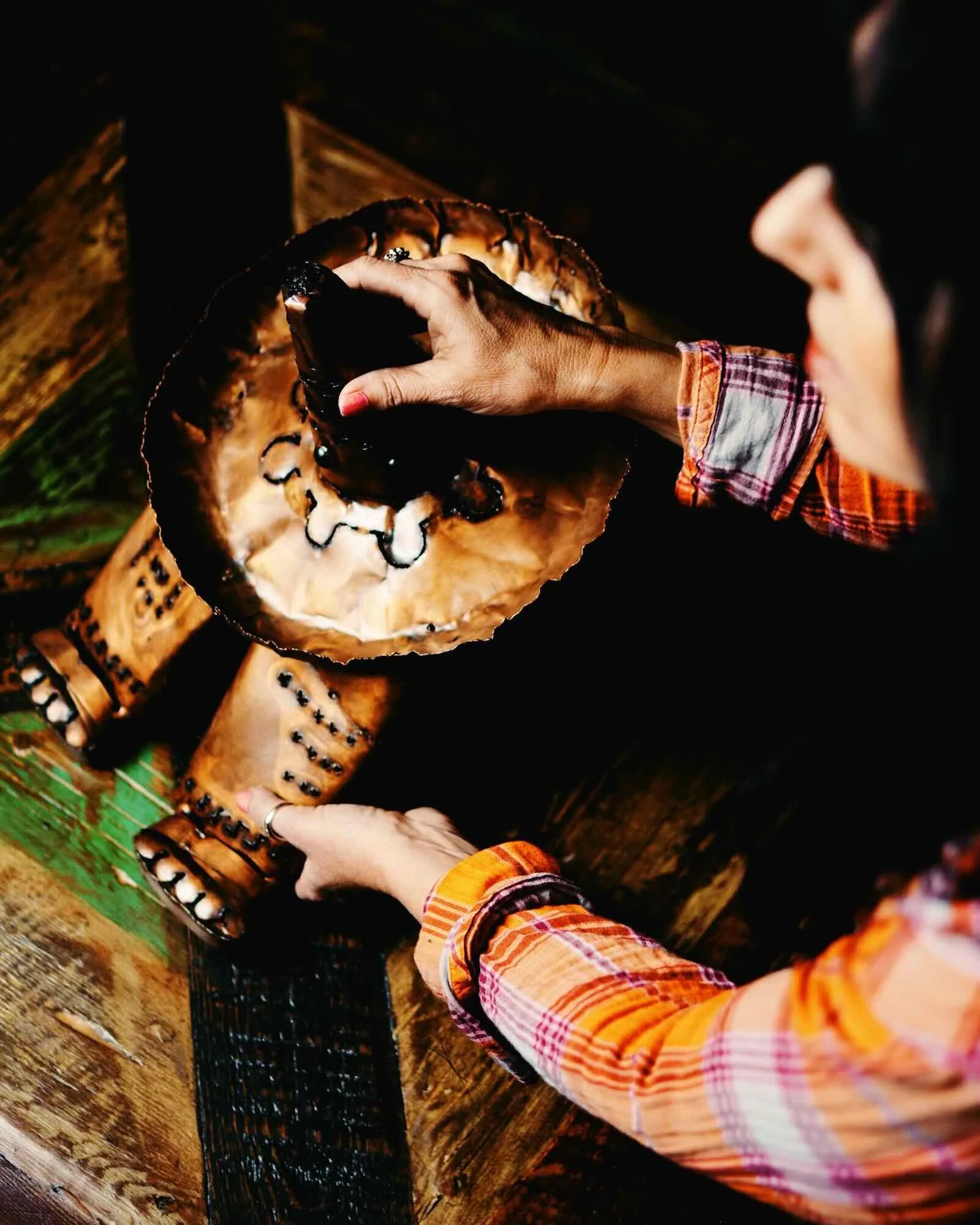 A pretty girl placing a bronze Siesta Man lantern from Mexico.