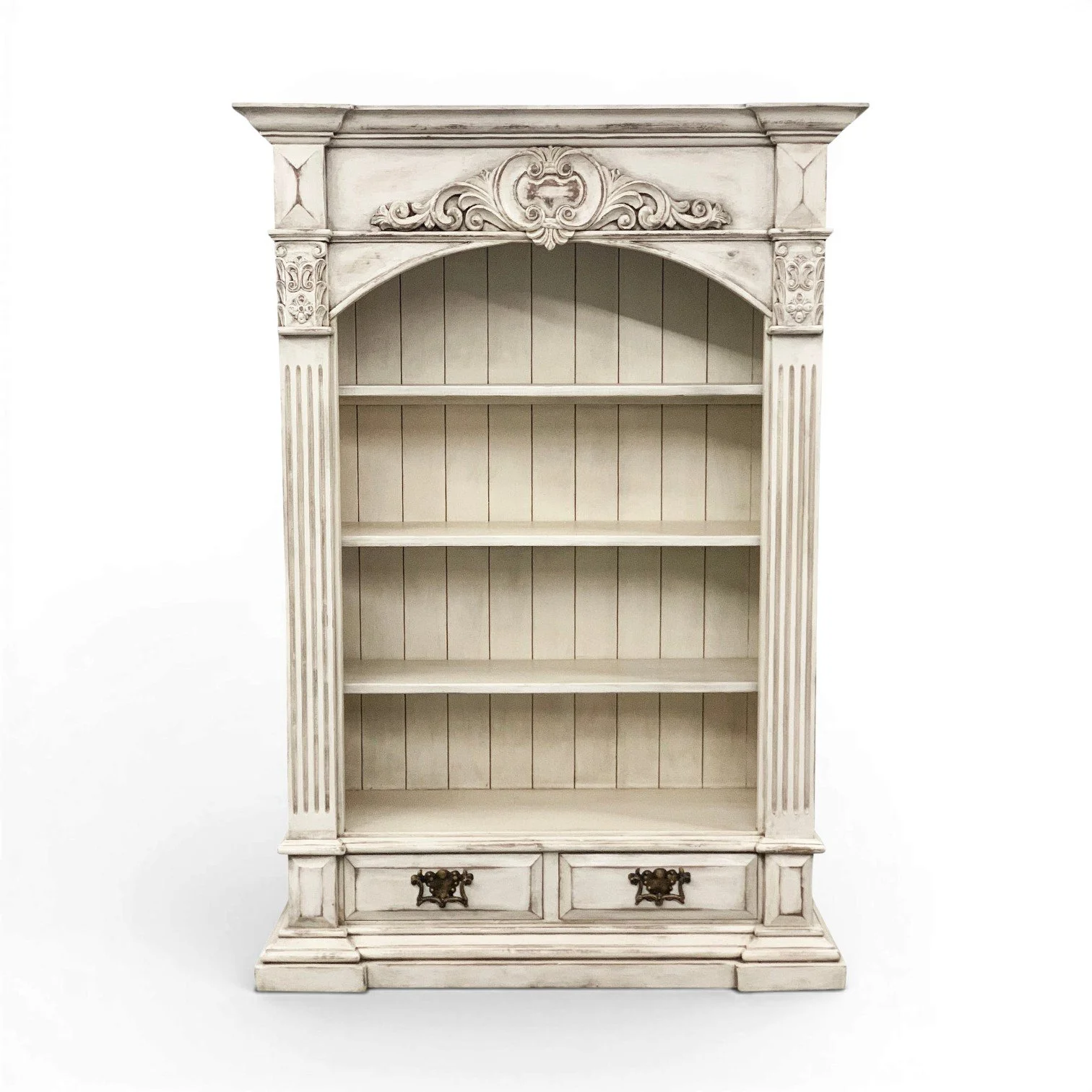 Cielo Antigua wood bookcase with ornate carvings, distressed finish, removable shelves, and lower storage drawers in Francesca white finish.