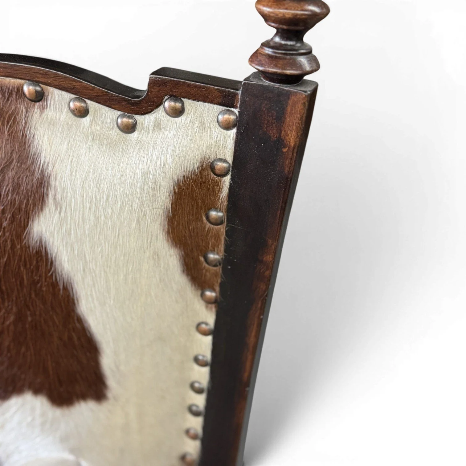 Handmade dining chair with cowhide back, leather seat, and carved wood frame