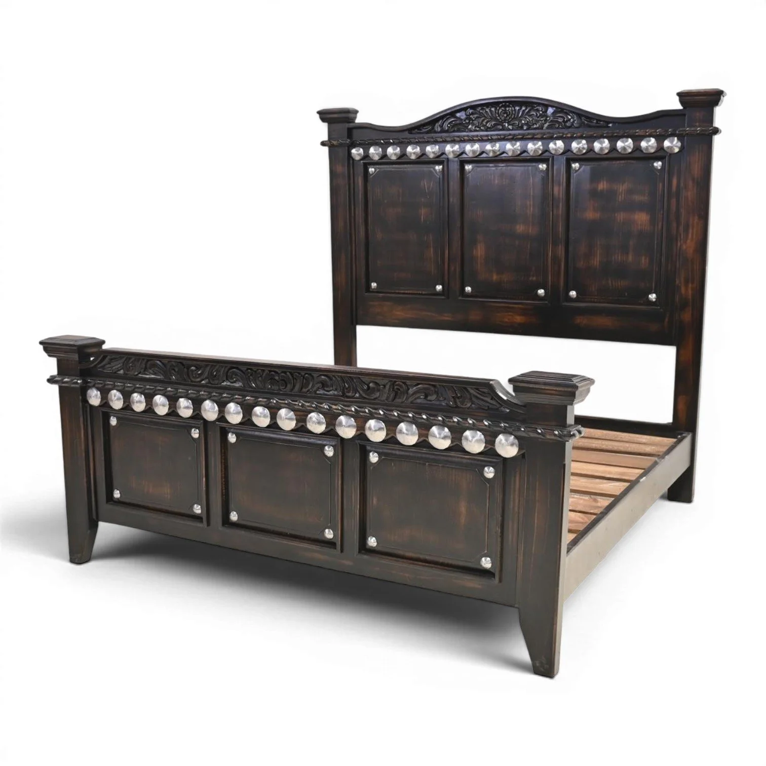 Handmade Arenas Negras bed with distressed black finish, hand-carved details, and silver clavos accents