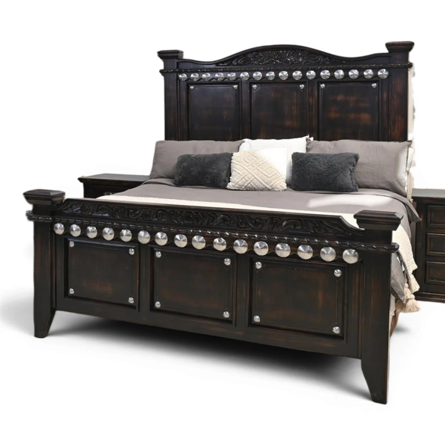 Handmade Arenas Negras bed with distressed black finish, hand-carved details, and silver clavos accents