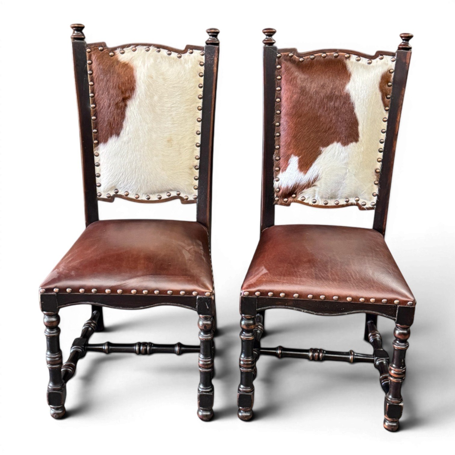 Handmade dining chair with cowhide back, leather seat, and carved wood frame