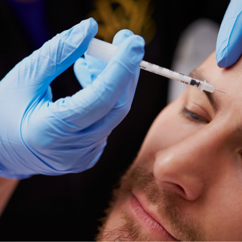 A person undergoing a cosmetic or medical injection procedure on their forehead, with a healthcare professional wearing blue gloves administering the injection.