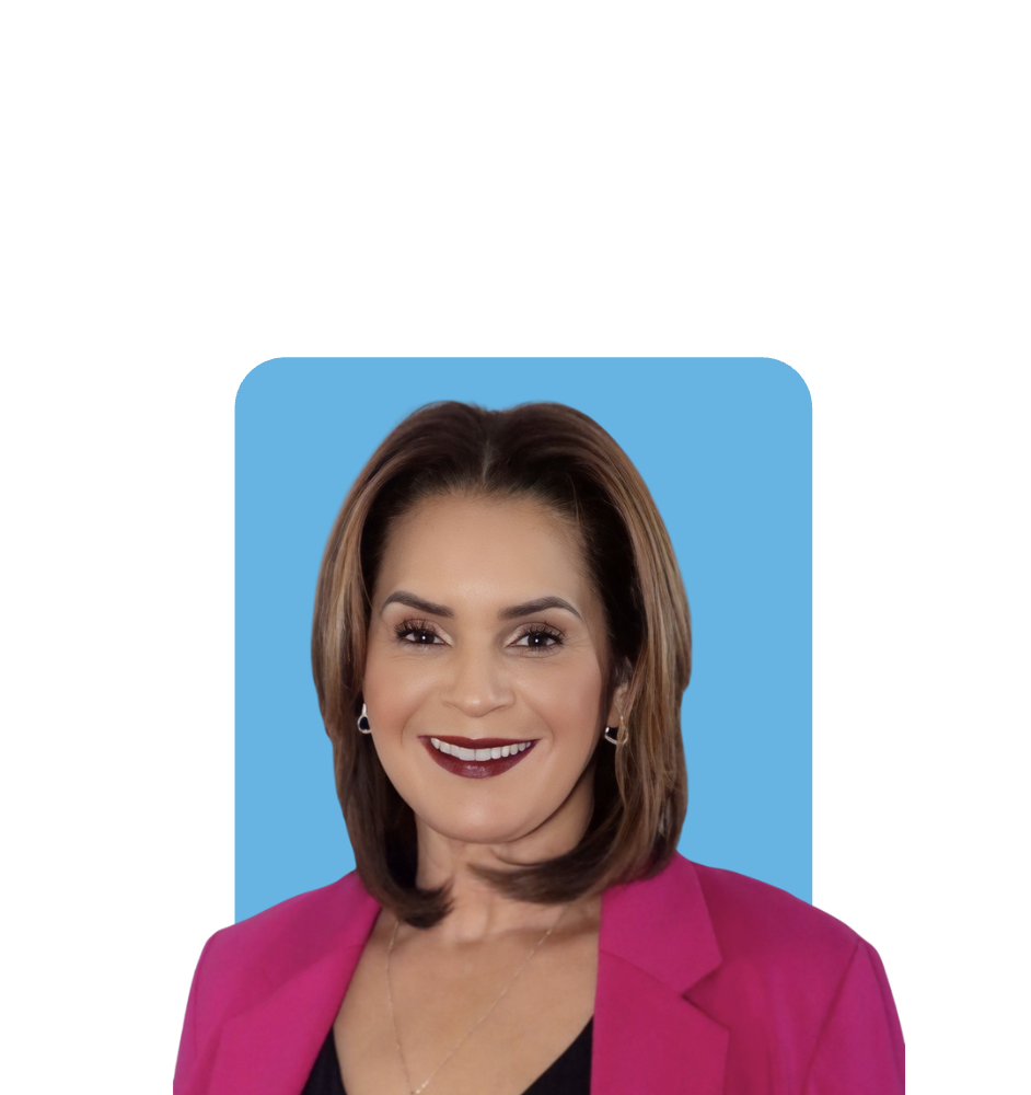 Portrait of a smiling woman in a pink blazer against a blue background.