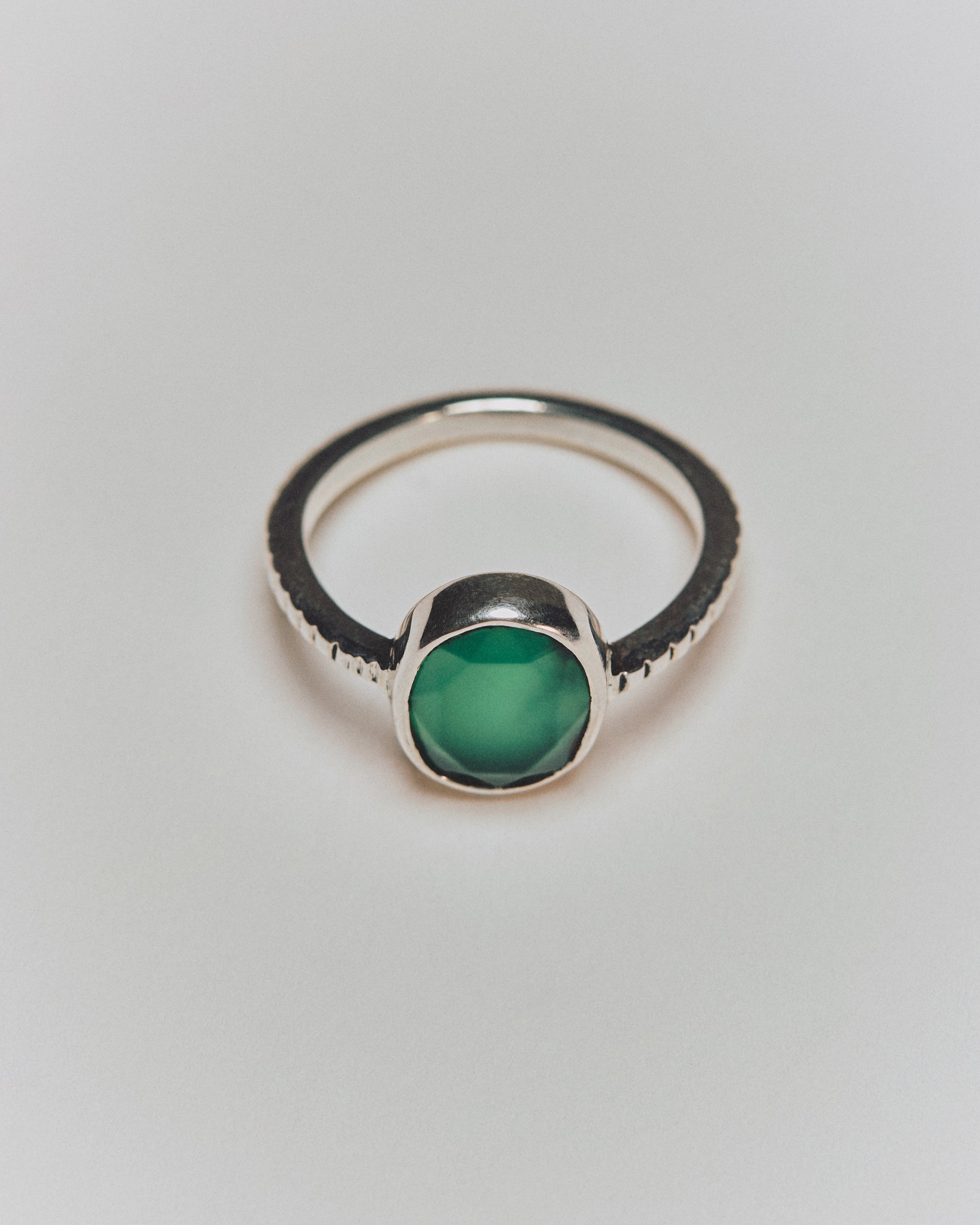 Silver ring with a green gemstone
