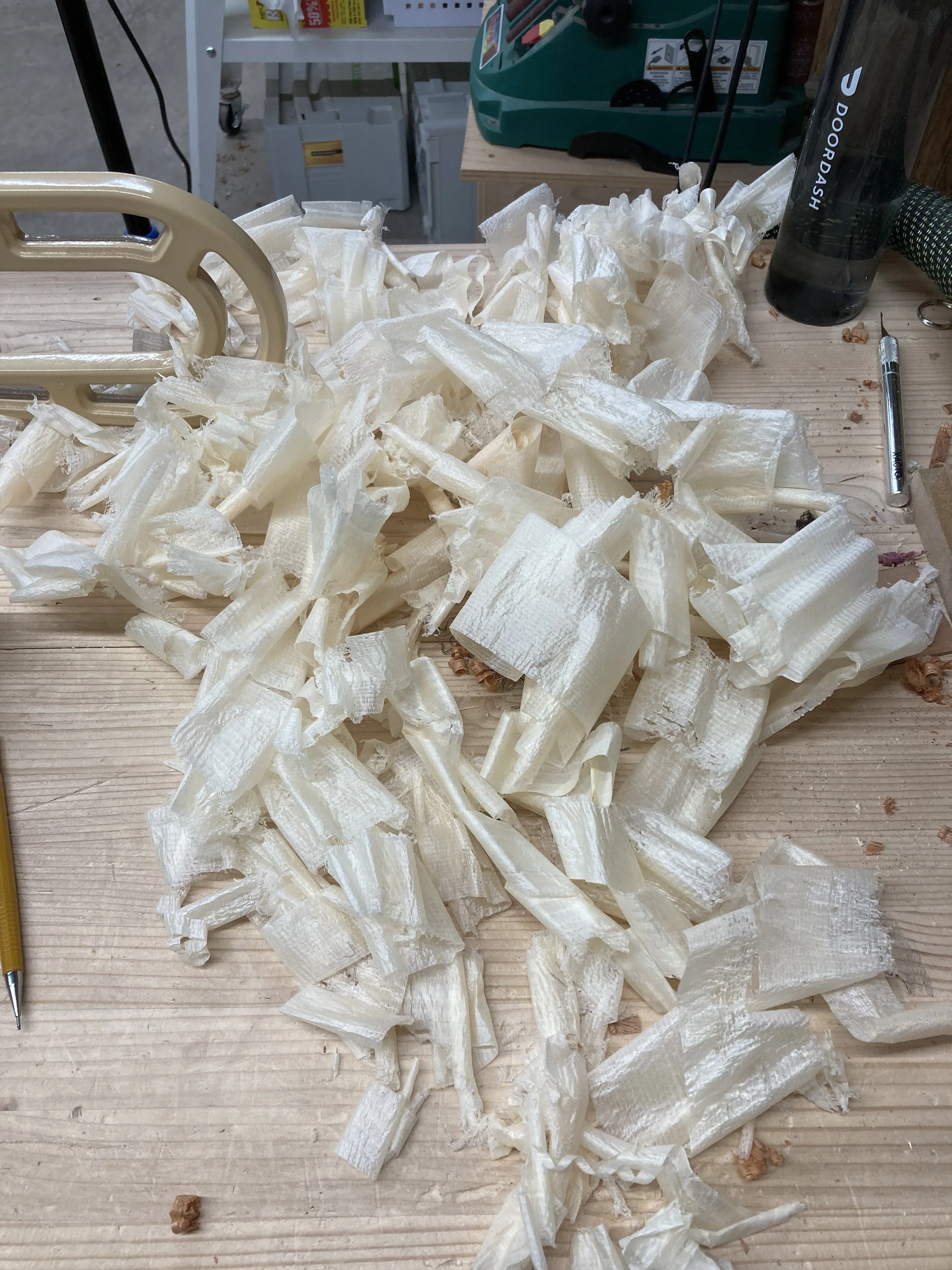 Wood shavings on a workbench with tools