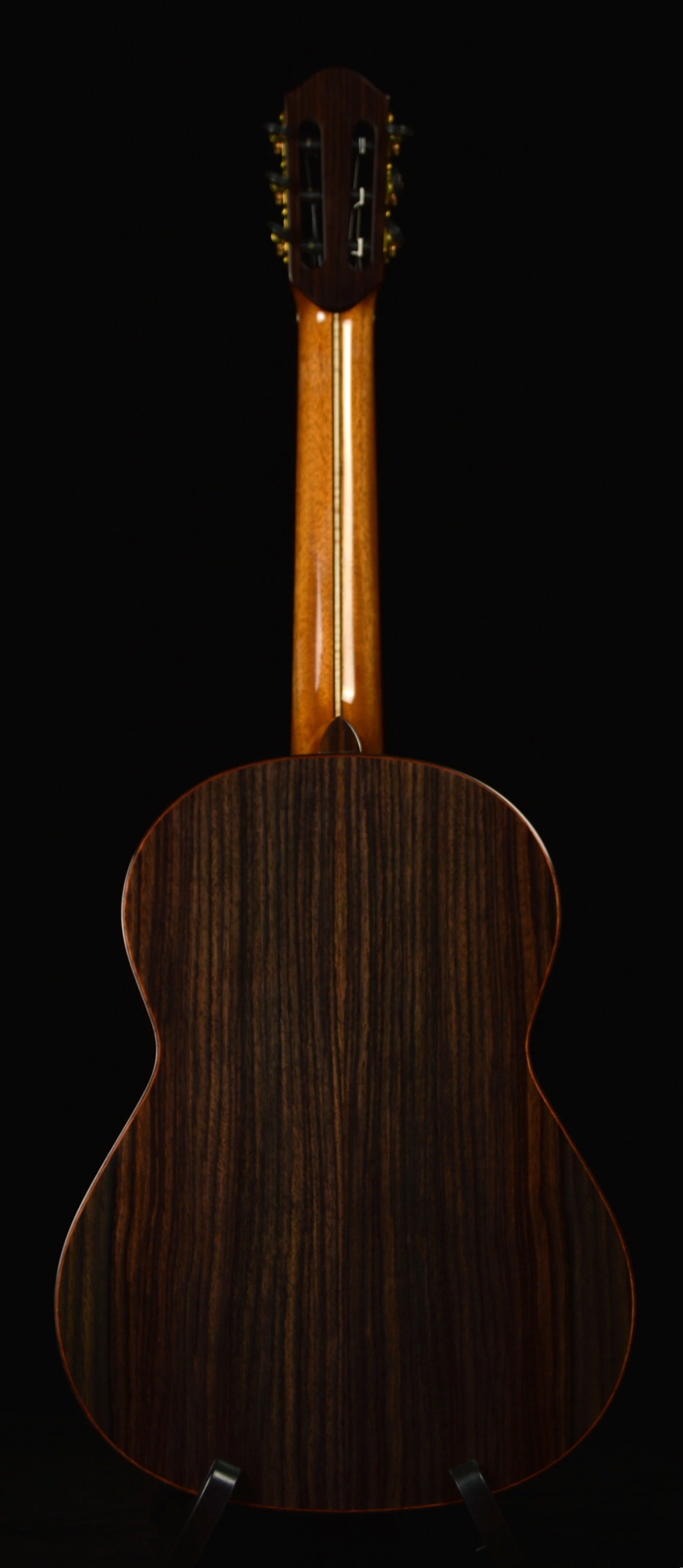 Close up of a Classical guitar with rosewood back and sides on black background