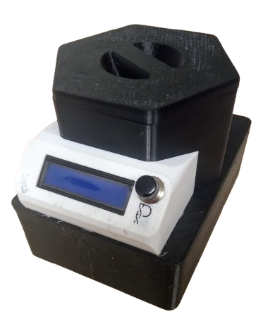 A black and white laboratory instrument with a digital display and a rotary knob, placed on a black base.