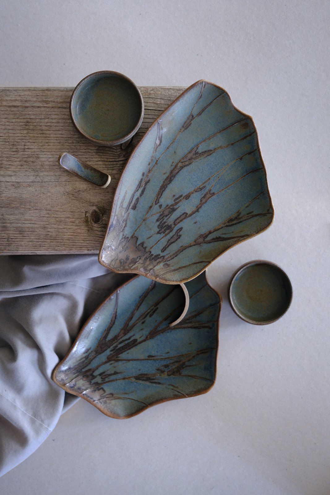 Handmade organic japandi sushi set in blue-gray earthy opaque tone with bronze accents.