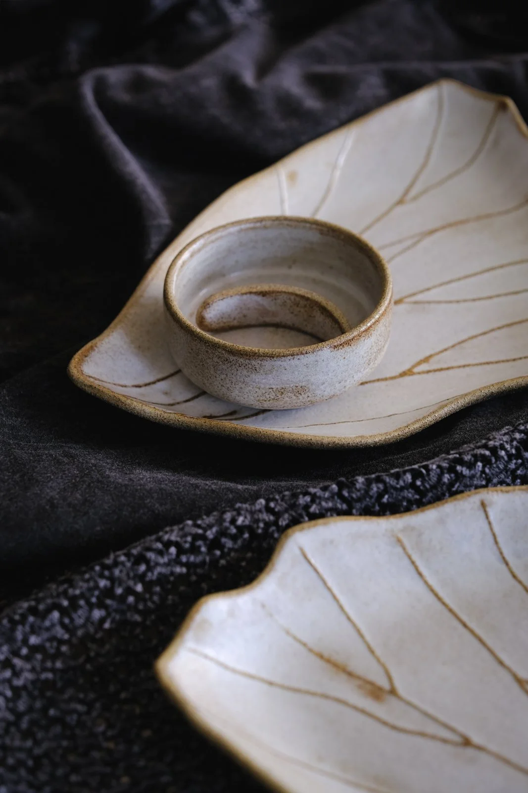 Close-up of the opaque off-white finish with rustic brown accents and bevel line decoration.