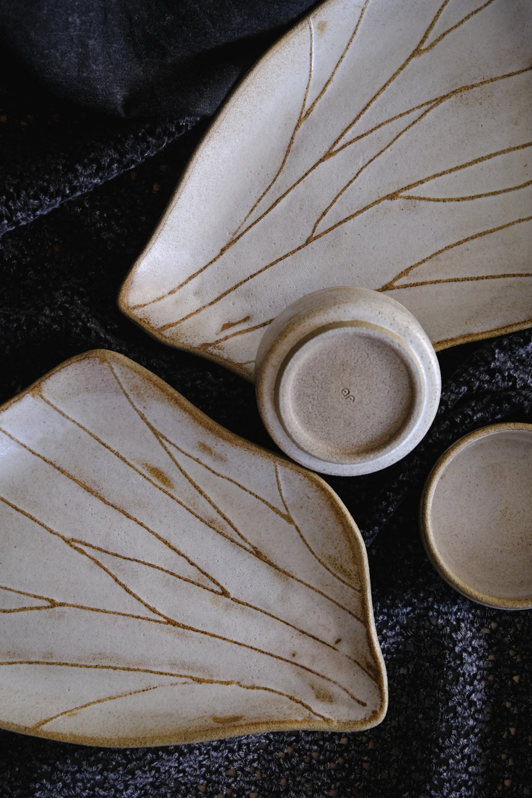 Handmade, organic, wavy sushi trays, matching bowls and bent chopsticks rests.