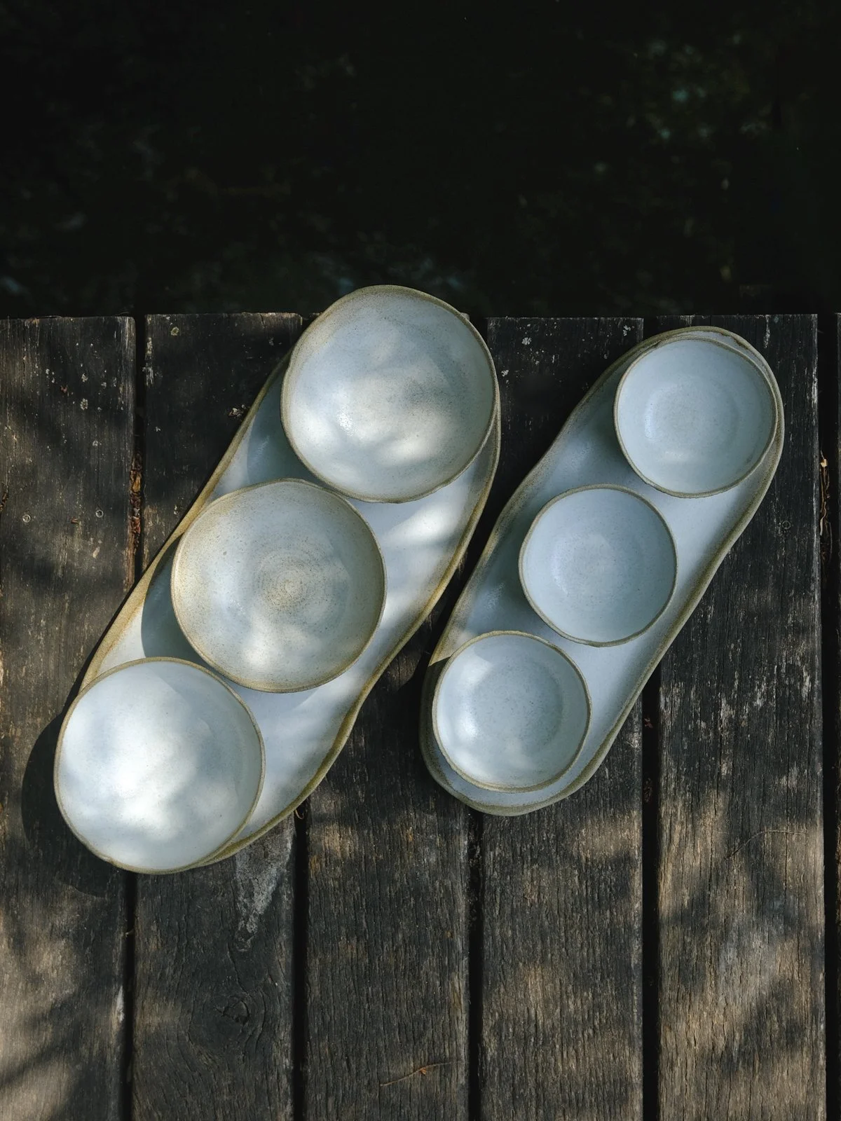 Size comparison of big and small Earth Tapas Sets featuring natural wabi-sabi pieces.