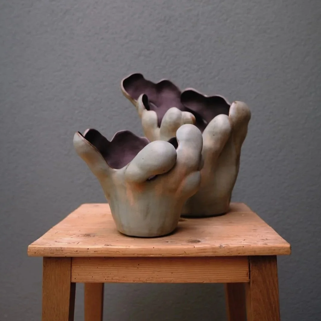 Sulptural vases or statement pieces in organic expressive seeweed-like form, in black clay and blue-grey satin finish.
