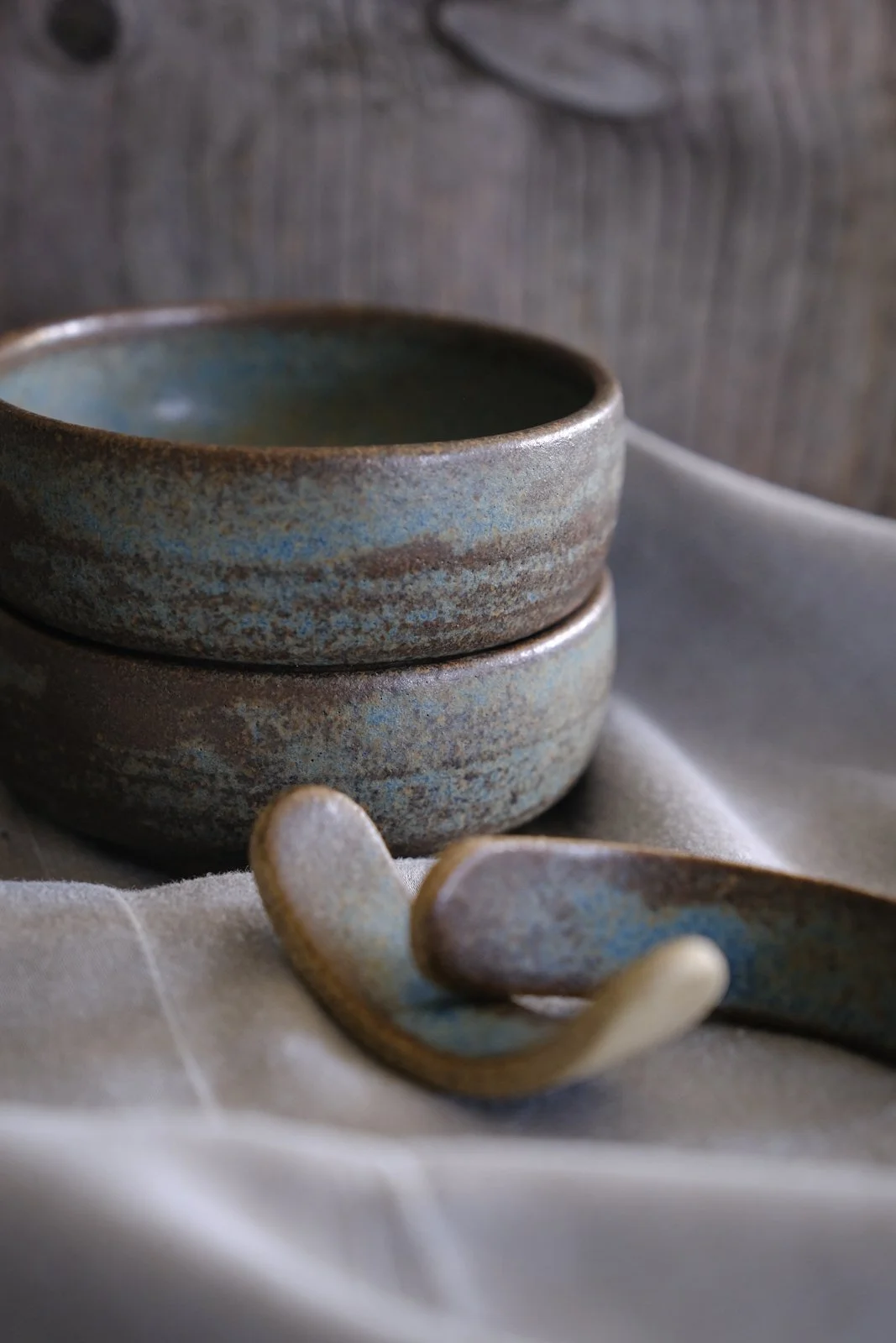 Blue-grey glaze with brown wabi-sabi organic accents on soy sauce bowls and chopstick rests.