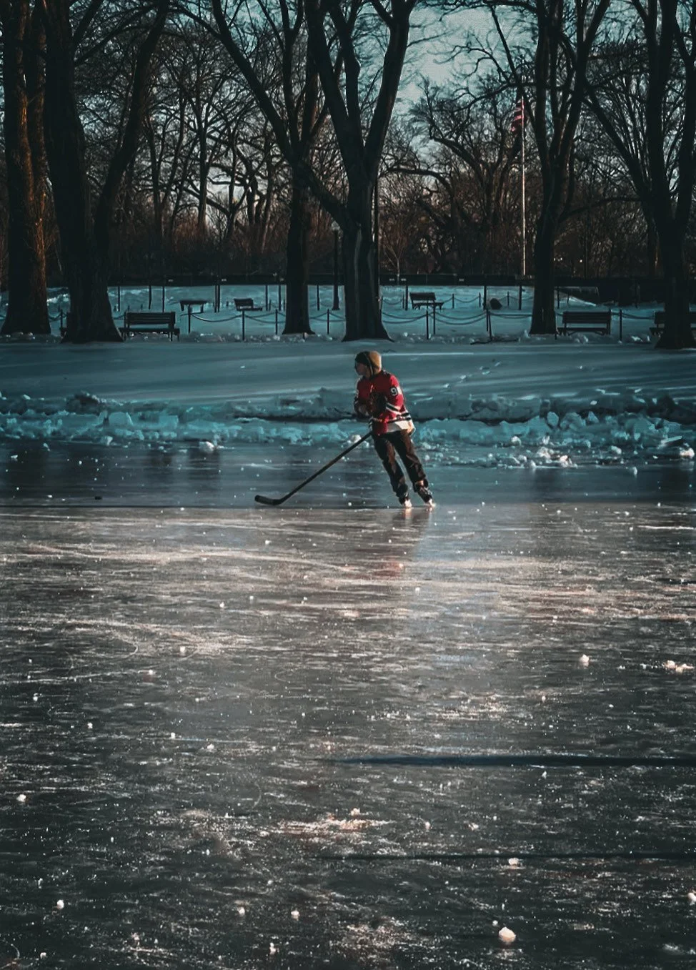 Man playing pond hockey