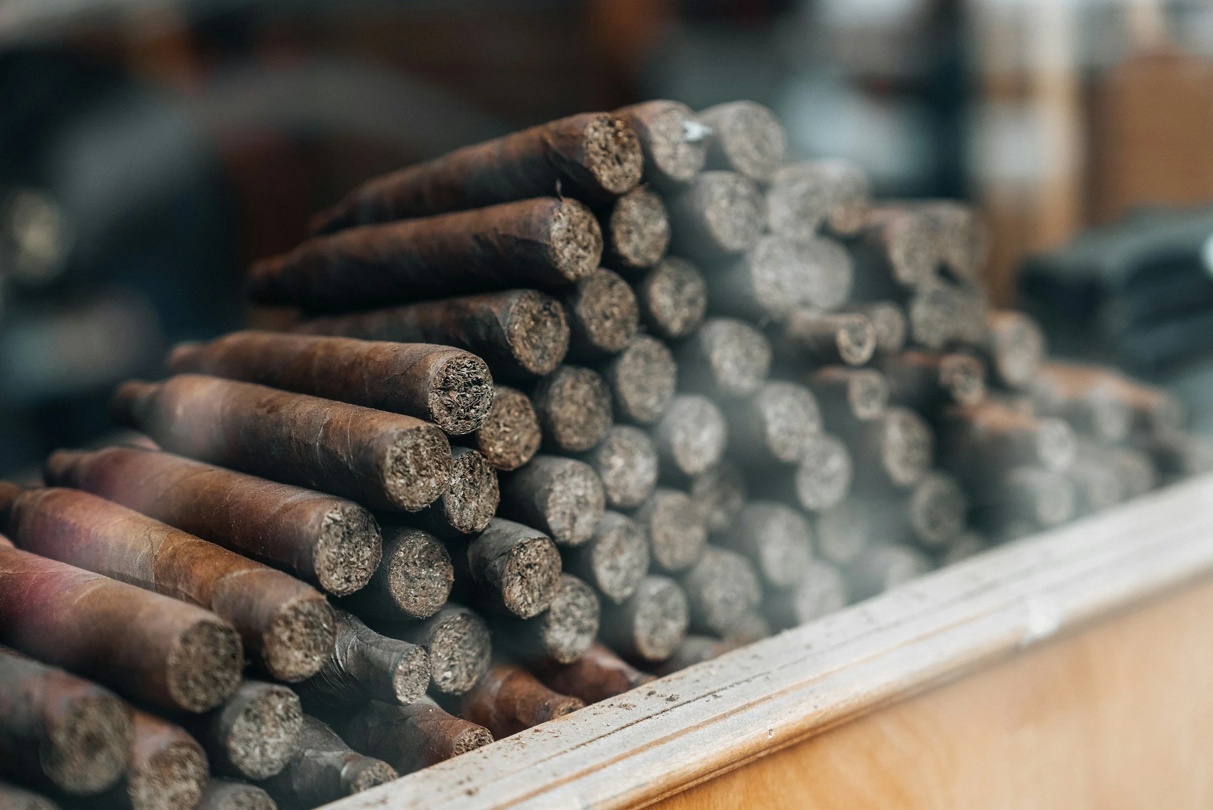 Close-up of stacked wooden dowels or sticks on a surface.
