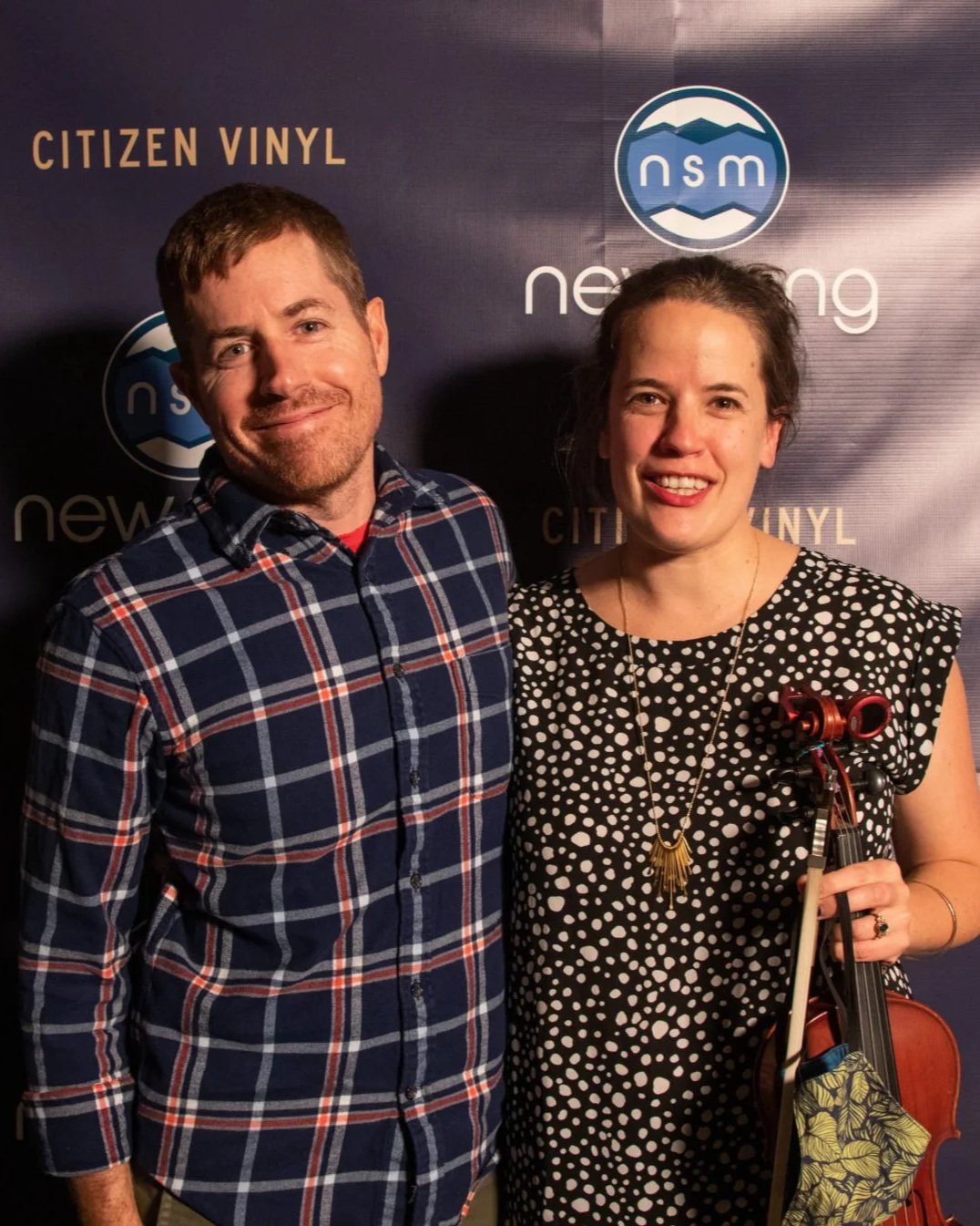 Michael Flynn, the 2021 NewSong Music Grand Prize Winner, poses with fiddle player Hannah Seng.