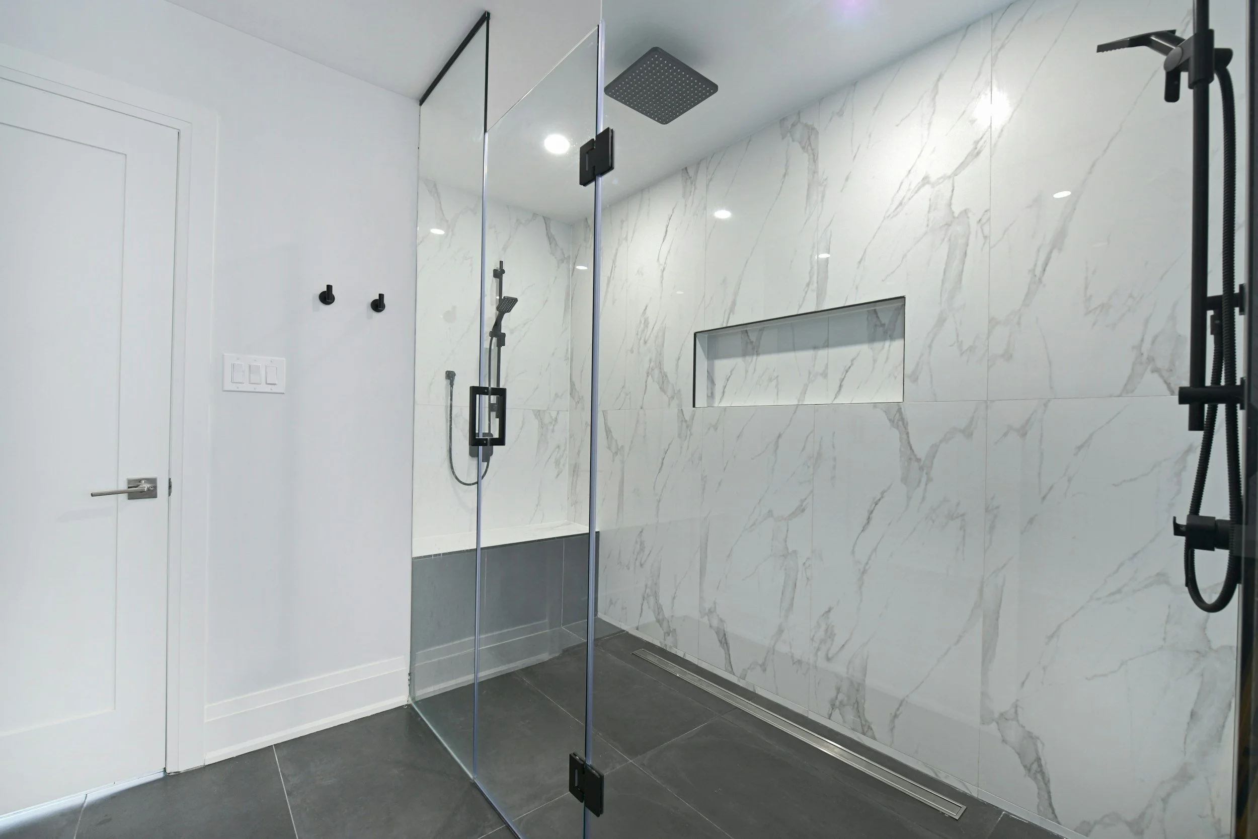 Modern glass shower enclosure with hydrophobic coating applied by Nano Diamond. Protects against hard water spots, soap scum, and mineral etching for residential bathrooms in Kelowna, BC.