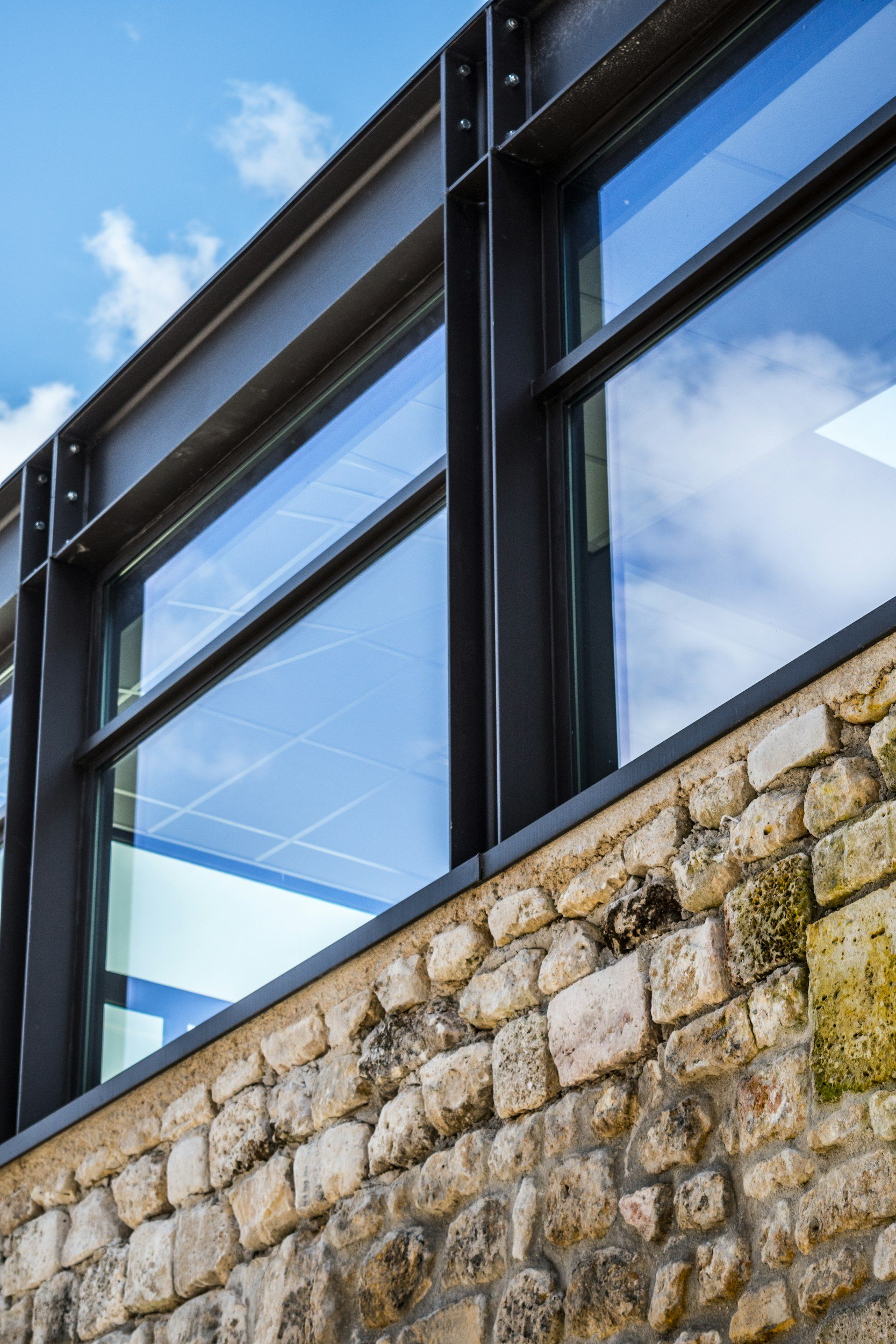 Exterior glass railings and balcony glass on a modern home featuring Nano Diamond hydrophobic coating. Prevents water spots and environmental debris for crystal-clear views in Kelowna, BC.