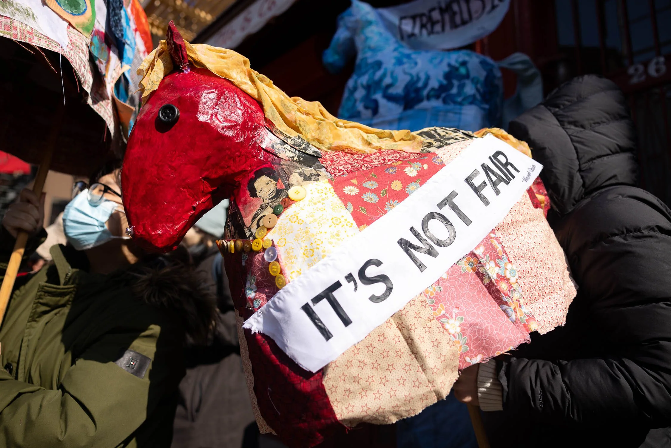 Fire horse, Cindy, in Chinatown. Cindy's body is made of collages of Vincent and Lily Chin and a patchwork quilt. Cindy also has a sash that reads "It's not fair."