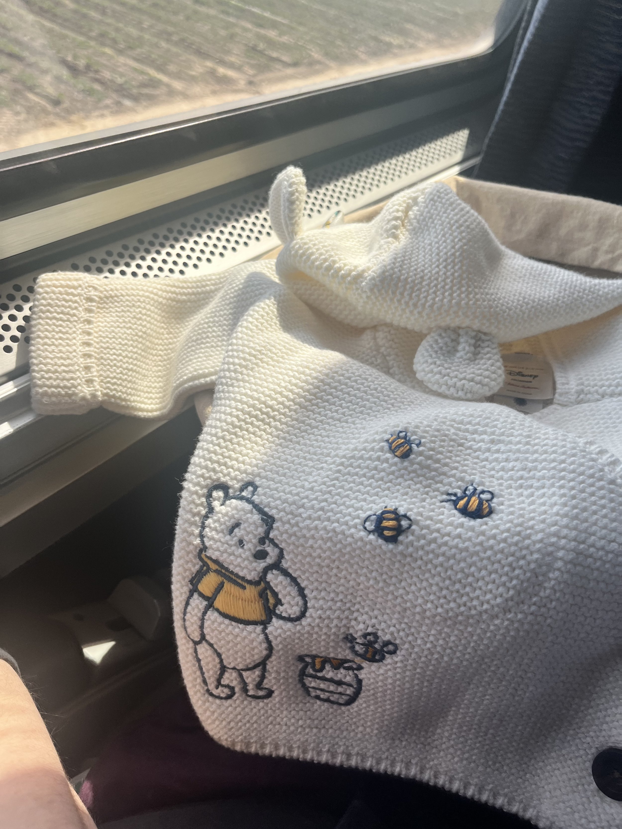 three handstitched cotton bumblebees on machine-embroidered sweater