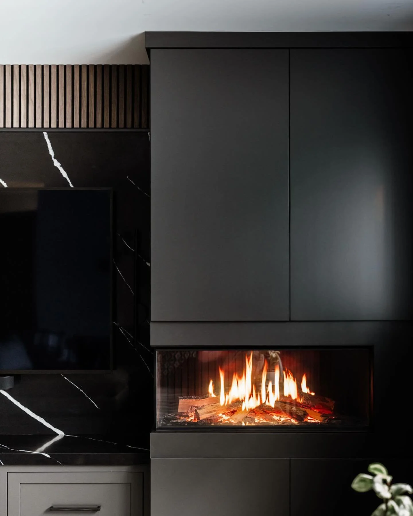 A few intentional upgrades to our basement &mdash; not a full reno, just thoughtful changes that made a big difference.
 Holographic electric fireplace by @davincifire installed by @energysaversfireplaces, walnut acoustic slat wall from @thewoodveene