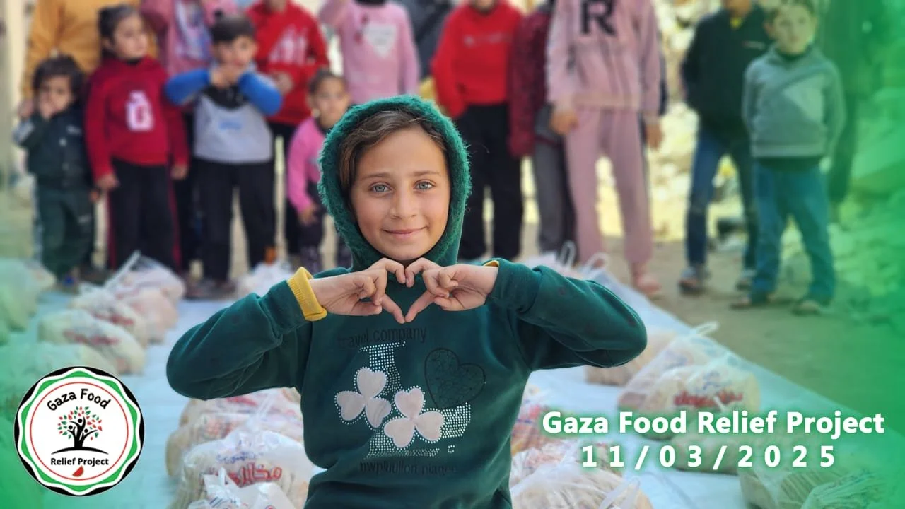 Child in green hoodie making a heart shape with hands in front of a group of children, with bags of food on the ground. Text: 'Gaza Food Relief Project 11/03/2025.' Logo: Gaza Food Relief Project.