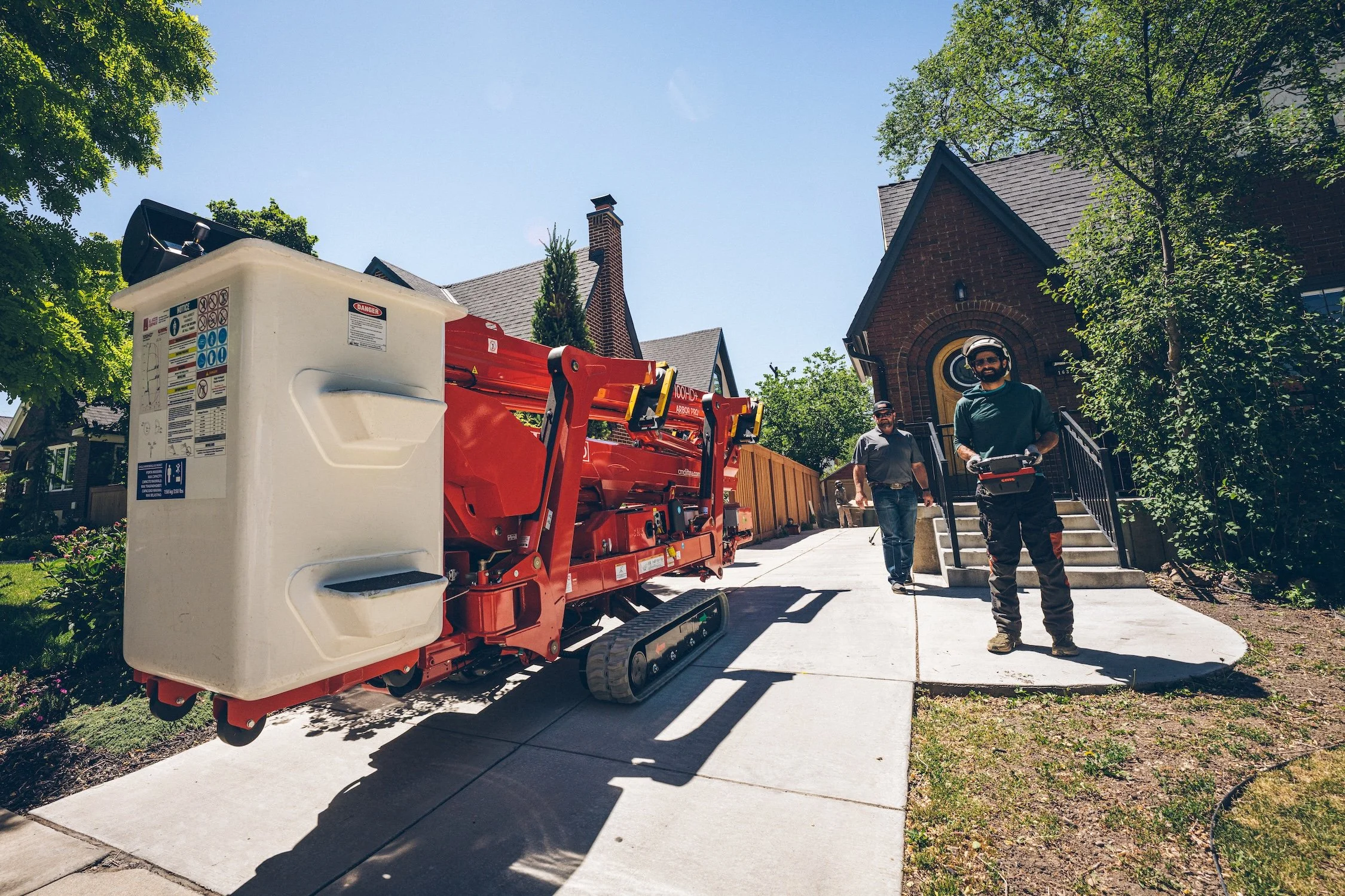 Our tracked lift fits through your gate so you don't need to pay for an expensive crane. We can work on trees in your side yard, back yard, or furthest corners of your property.