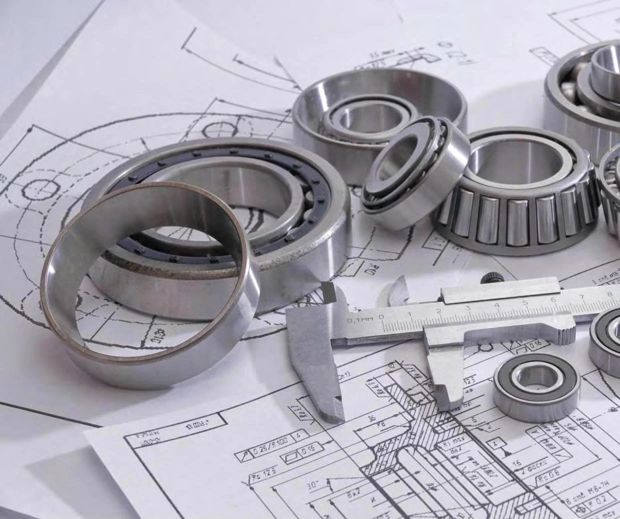 Bearings and a precision caliper arranged on mechanical engineering drawings.