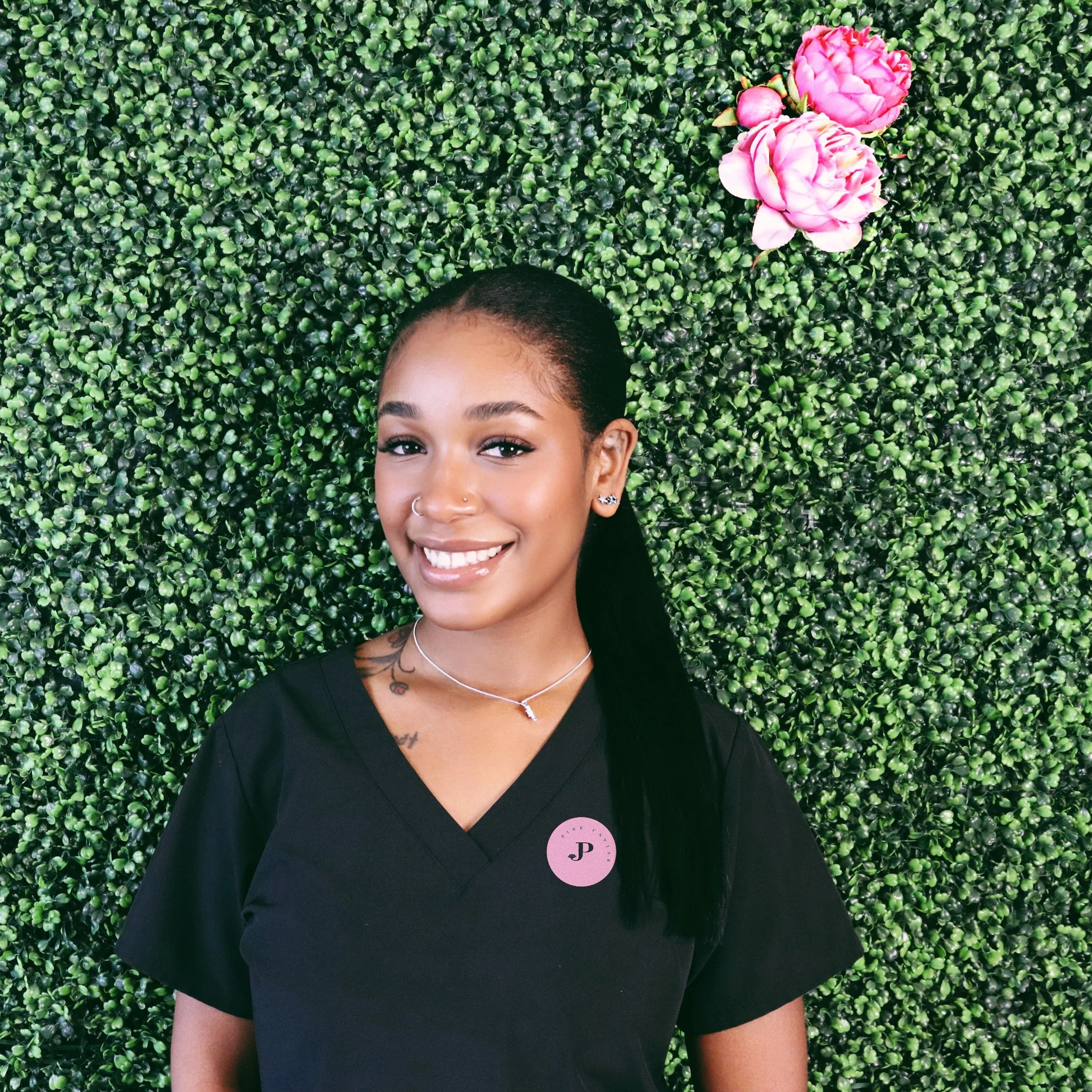 A textured green background with a pink rose in the top right corner and a diagonal black rectangle in the center with white text reading 'Photo Coming Soon!'