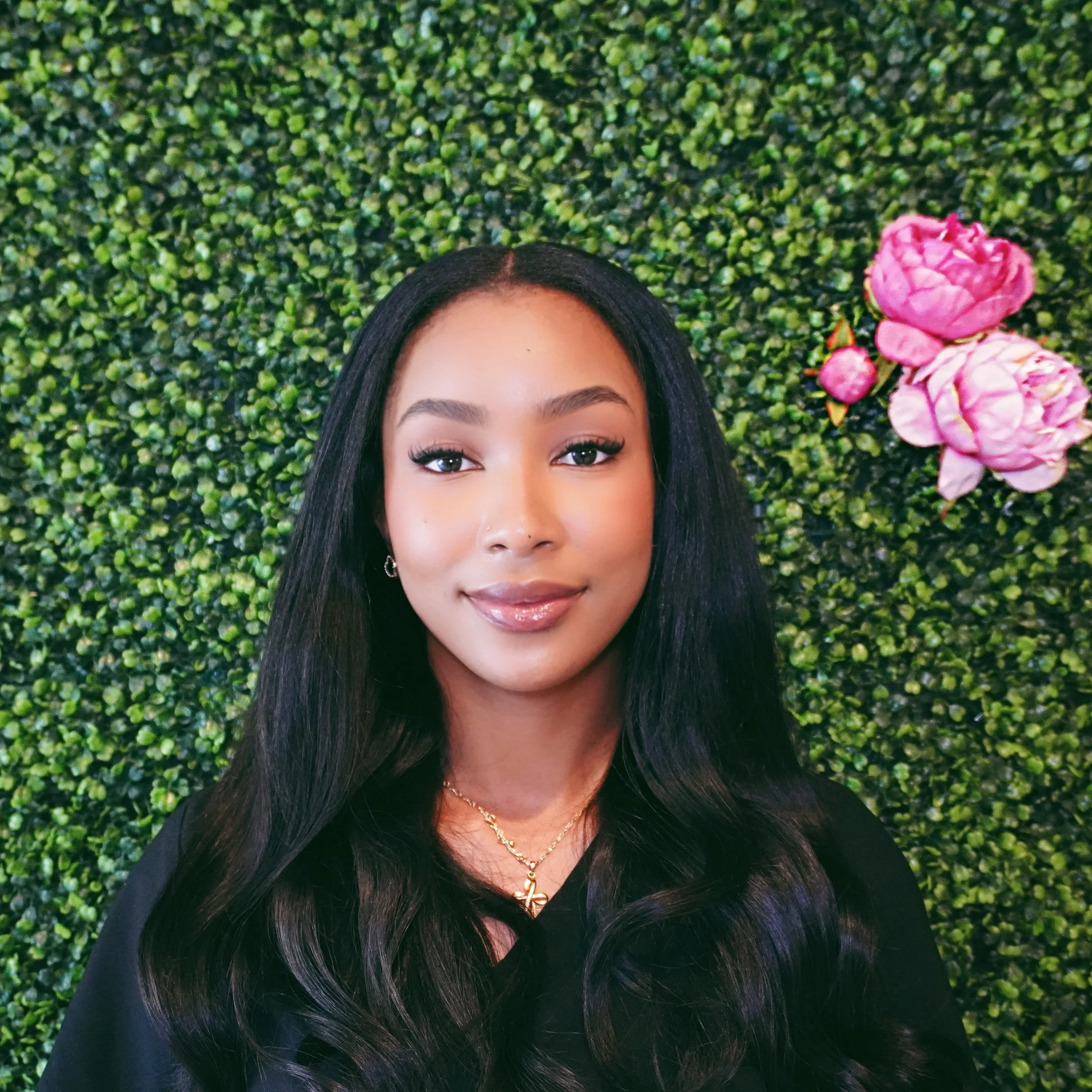 A graphic with a green, textured background and a pink flower in the top right corner. Text in the center reads 'Photo Coming Soon!' in white, bold letters with a shadow effect.