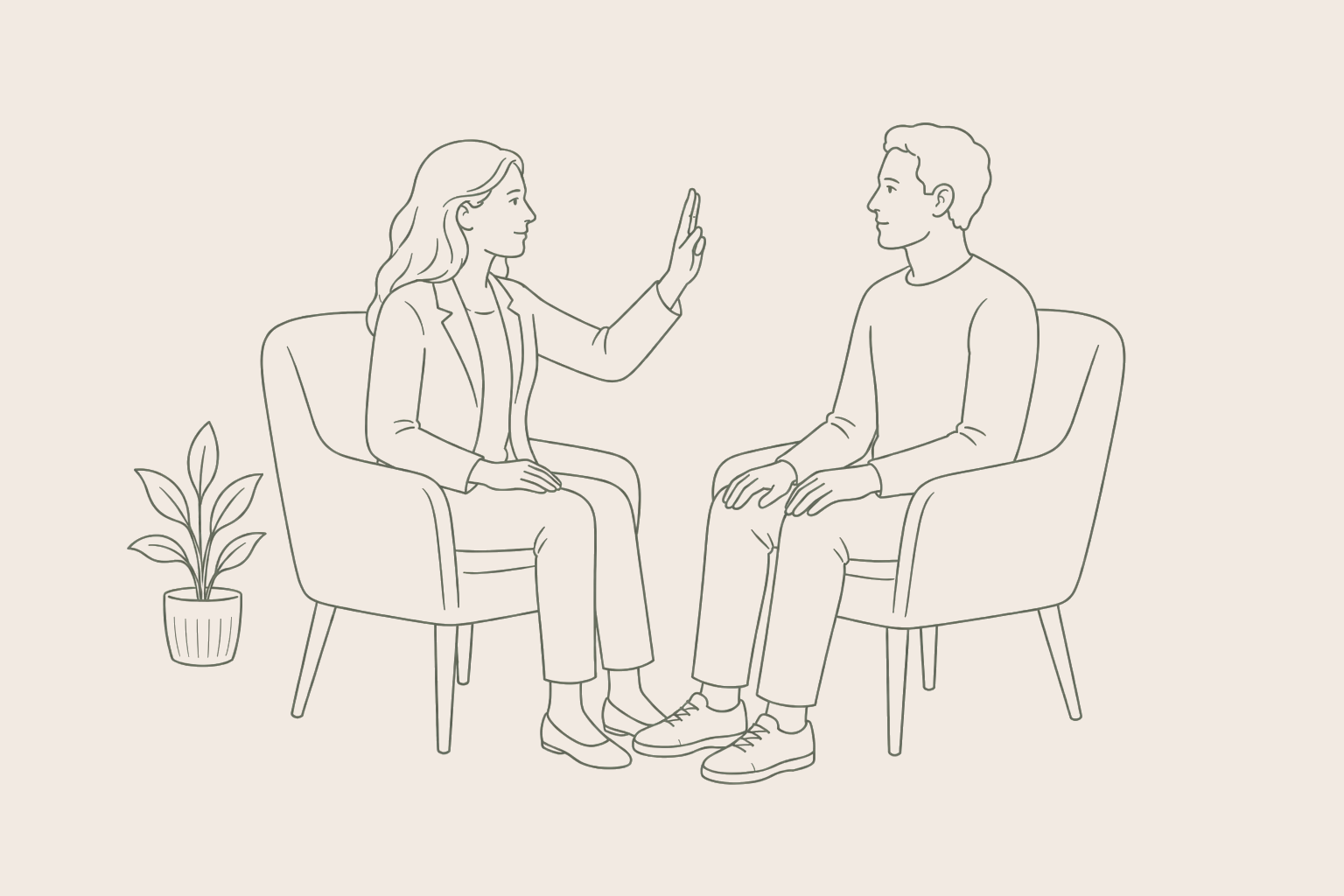 A woman and a man sitting in chairs, with the woman holding up her hand in a stop gesture.