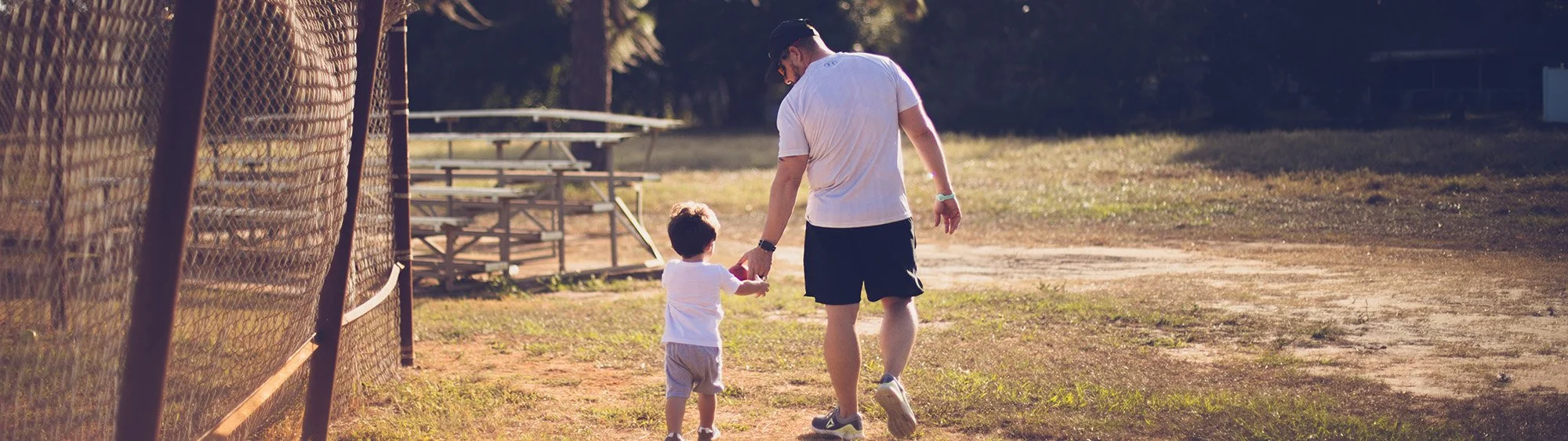 A father holding his son's hand