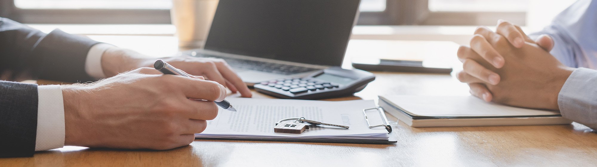 Two people signing a contract
