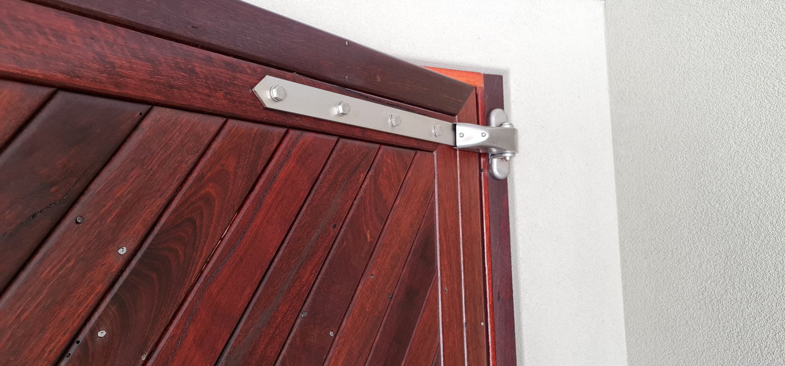 Strong, durable hinges installed to support a solid timber door.