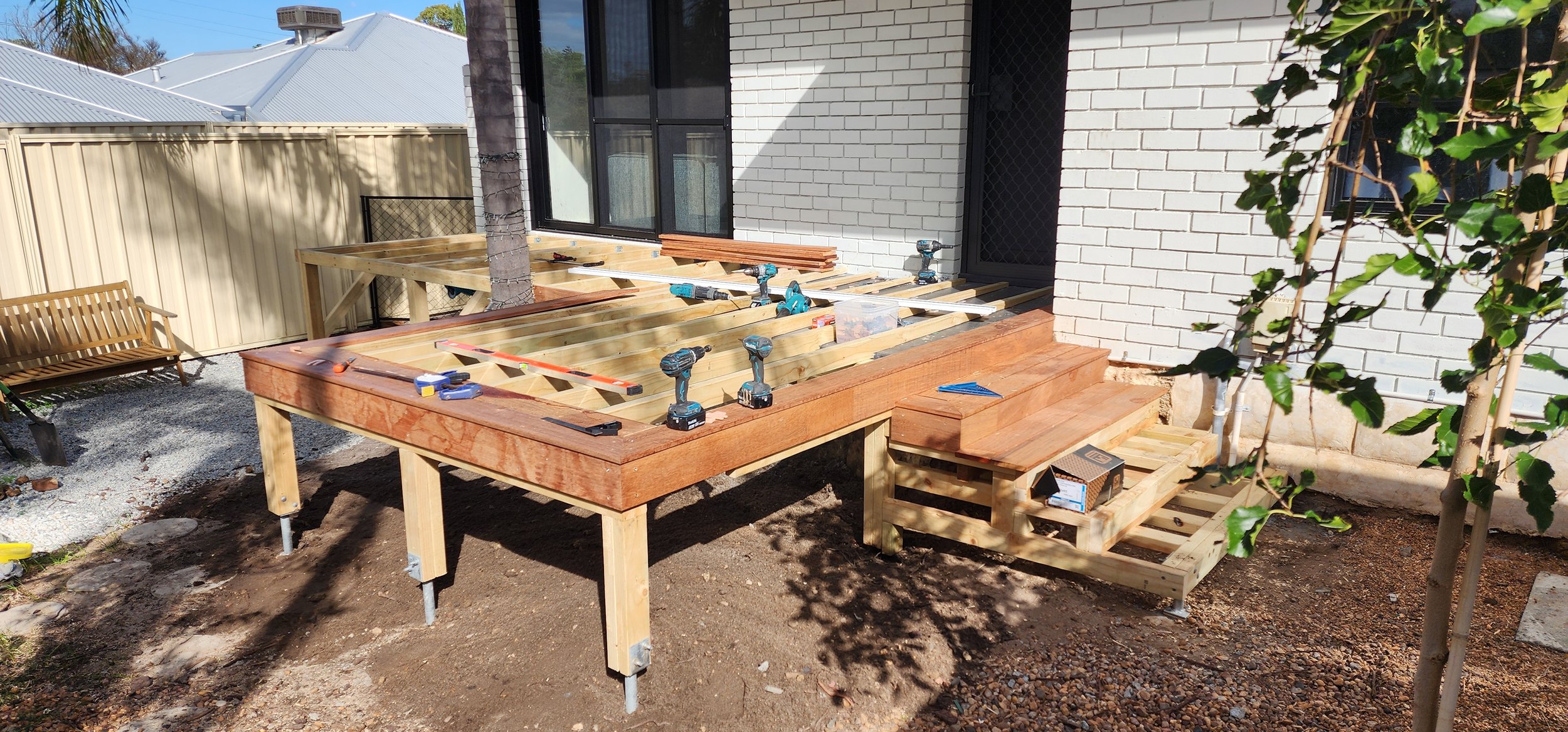 Wood Restore building elevated timber decking with stair structure.
