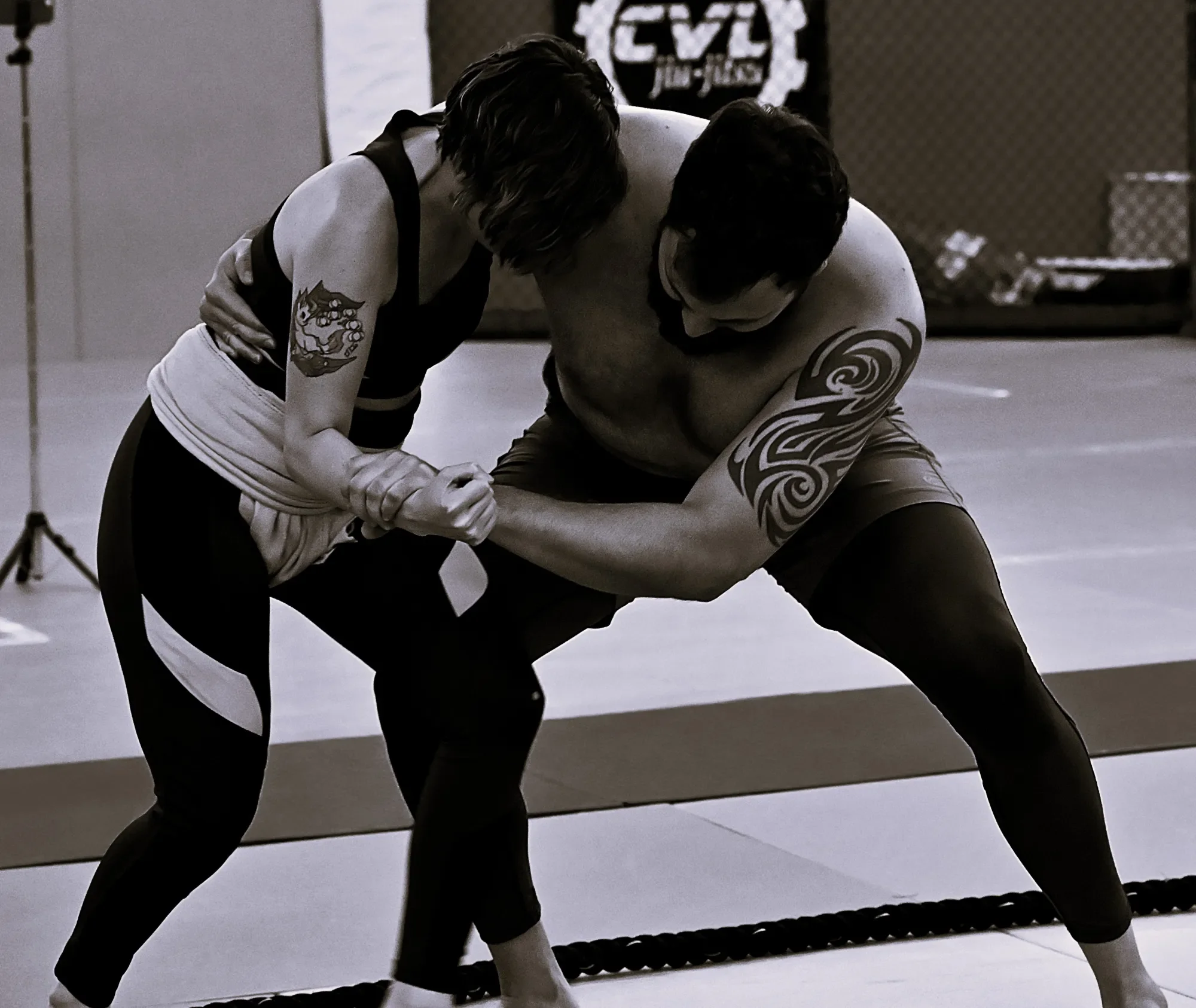 Two individuals engaged in a martial arts sparring or training session, demonstrating a fighting stance.