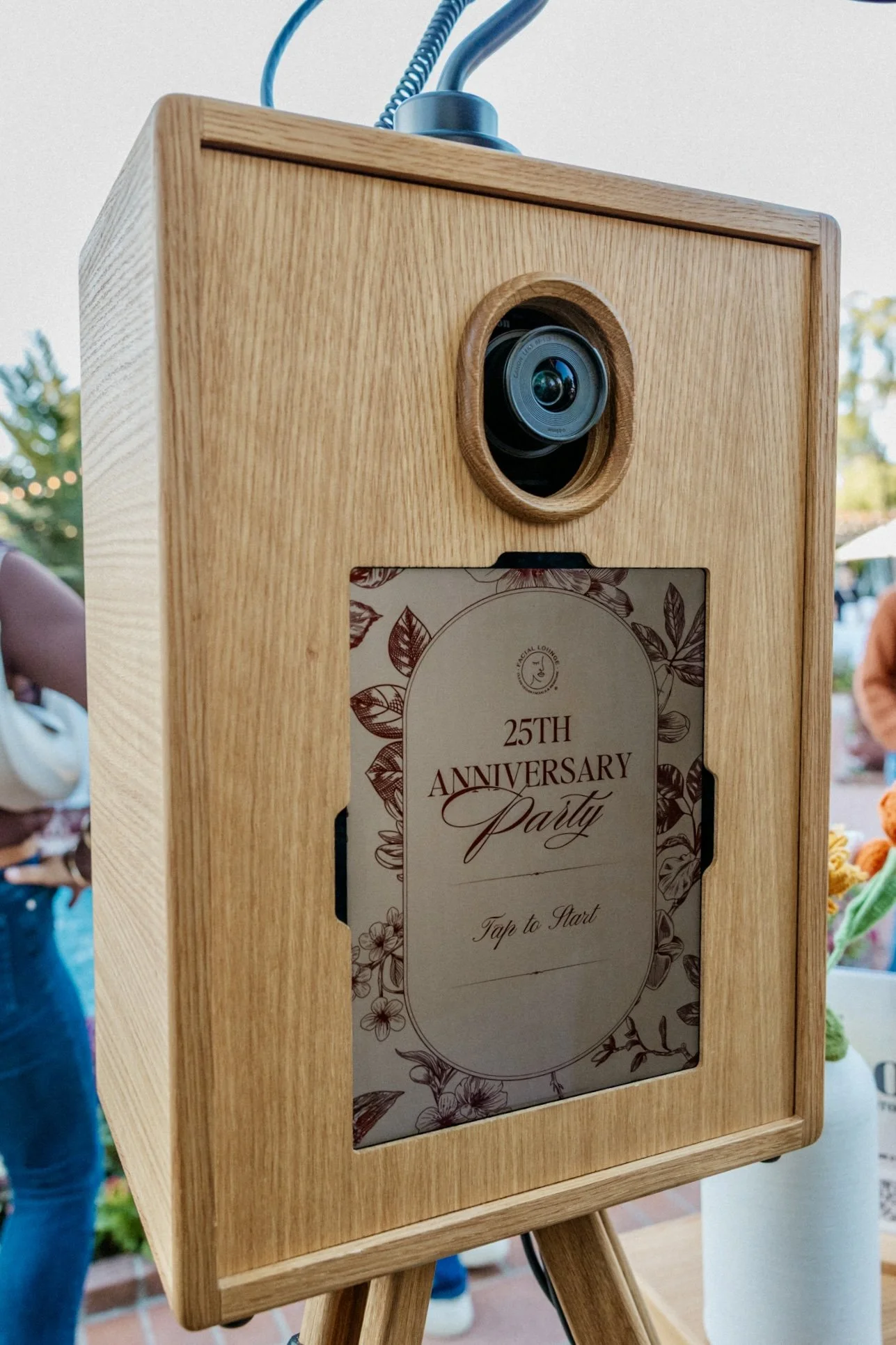 Oak + Bloom photo booth with custom-branded welcome screen reading “The Johnsons 09.12.24,” showcasing personalized event design on a handcrafted wood booth.